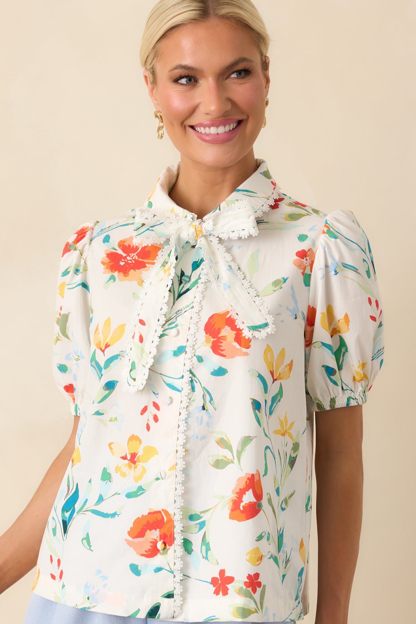 Focused view of the button front closure and floral pattern placement down the center.