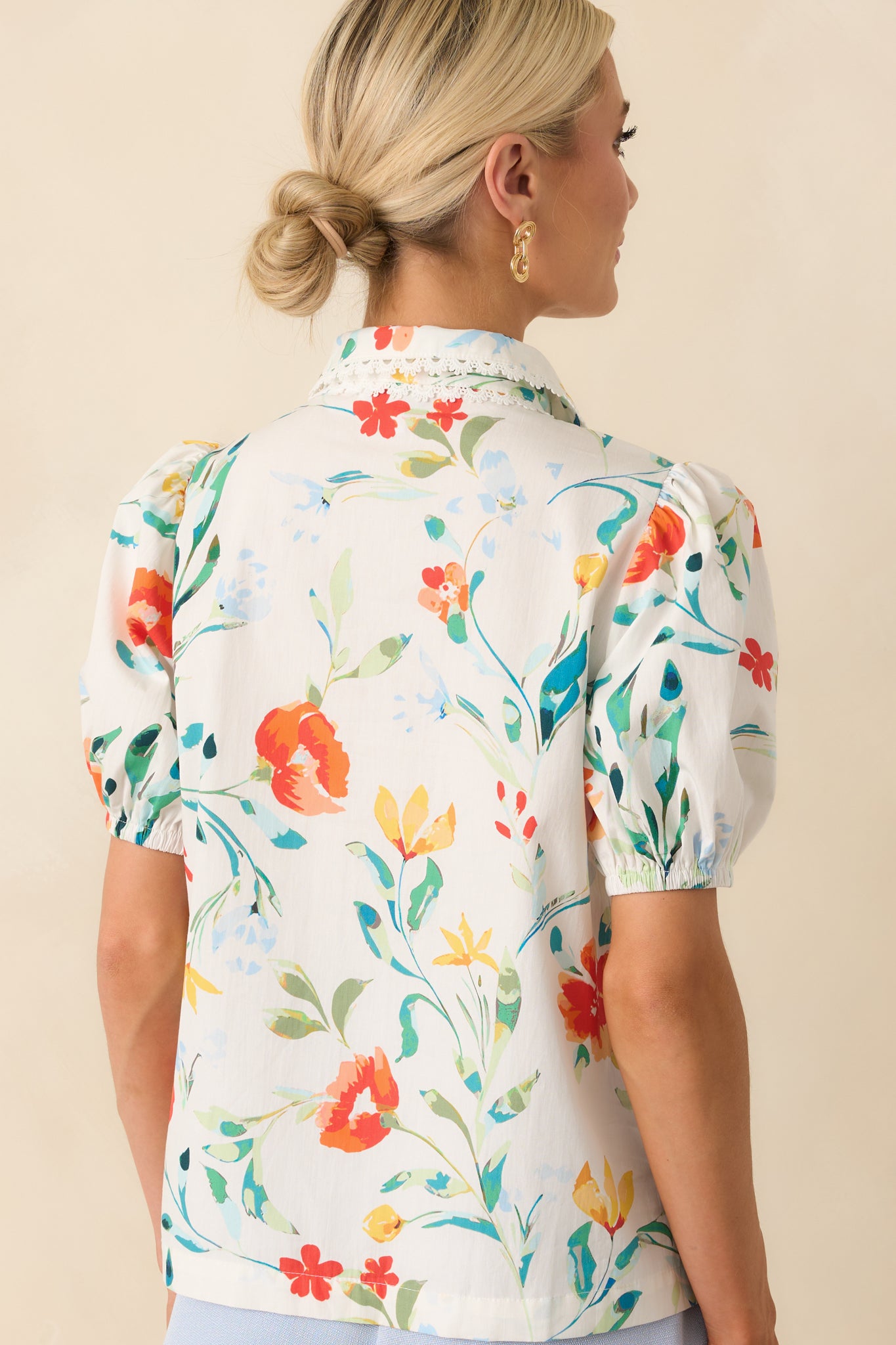 View from behind showing continuation of floral print and clean back panel with puff sleeve shaping.