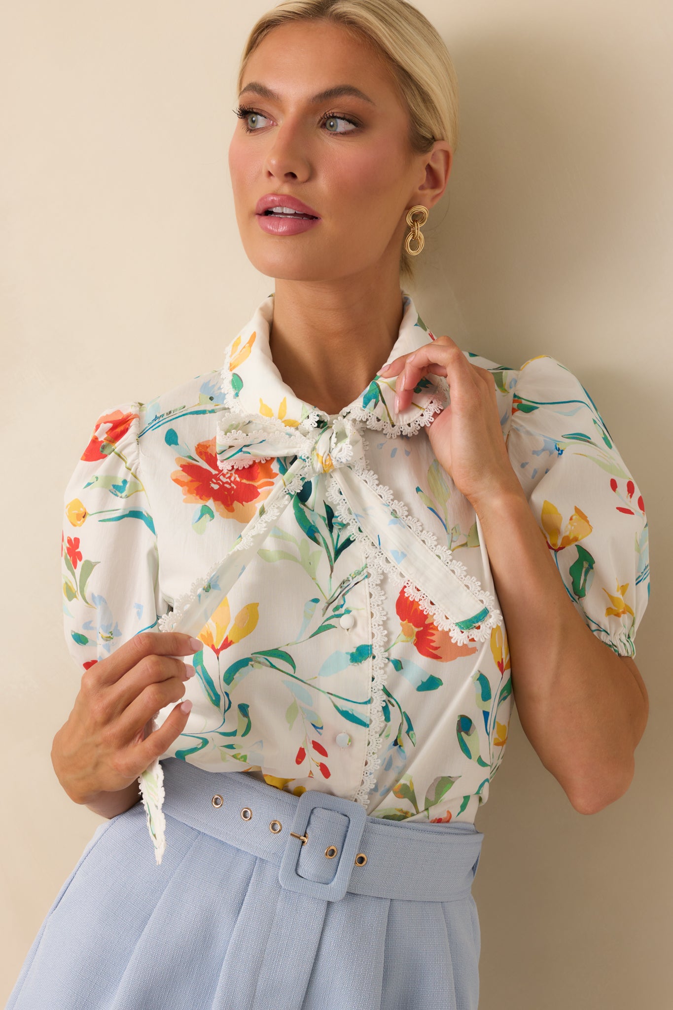 Tight crop on the lace scallop trim at the hem, showing fine detailing and fabric texture.