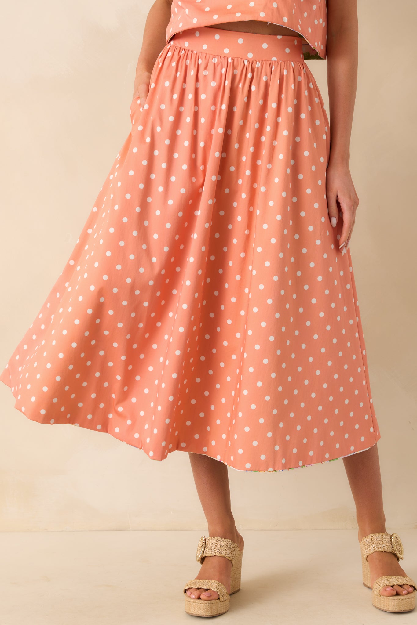 Detail of the elastic waist gathering on the polka dot fabric.