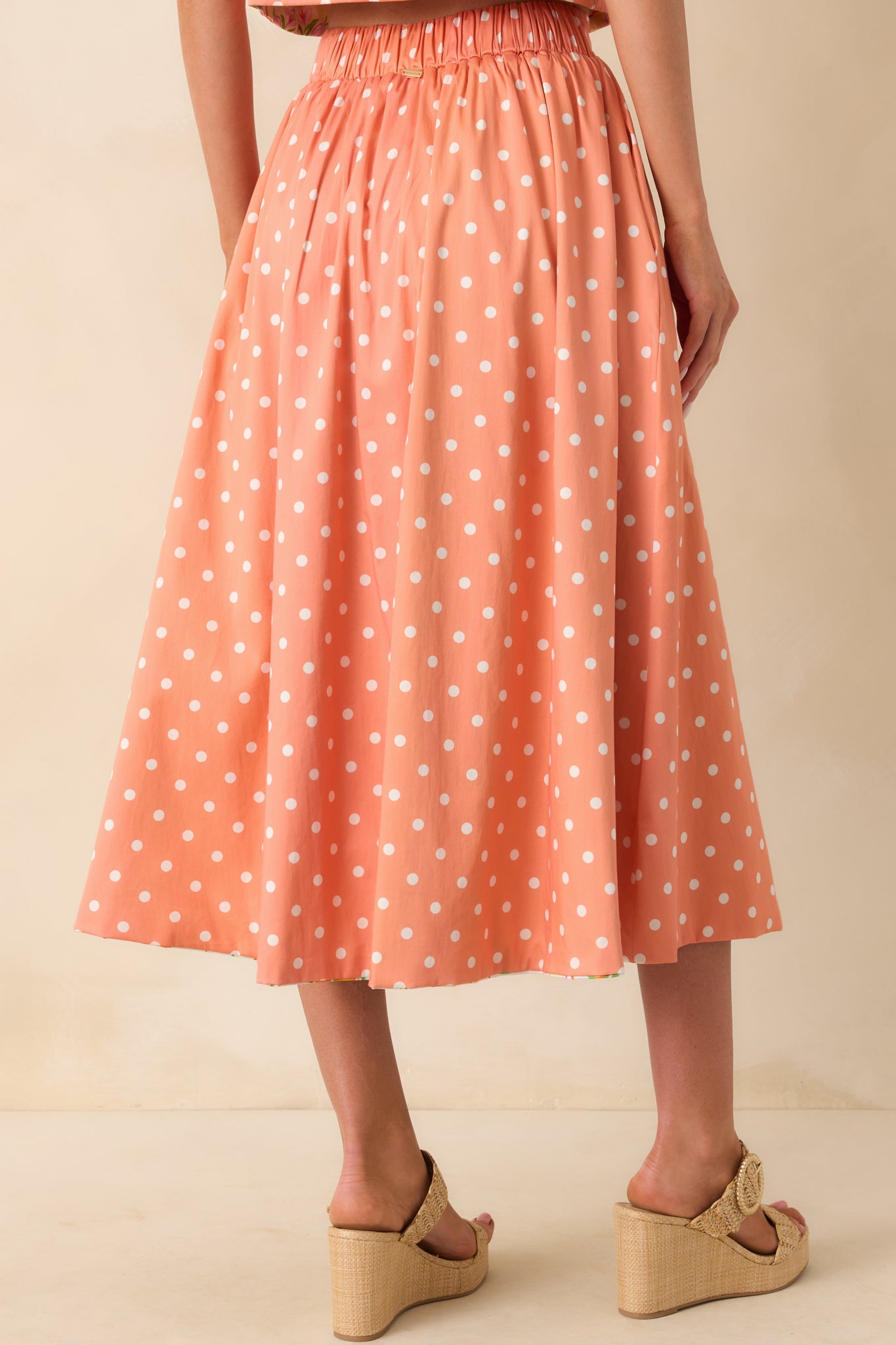 Back view of the skirt’s polka dot side featuring gathered elastic waist and clean fabric finish.