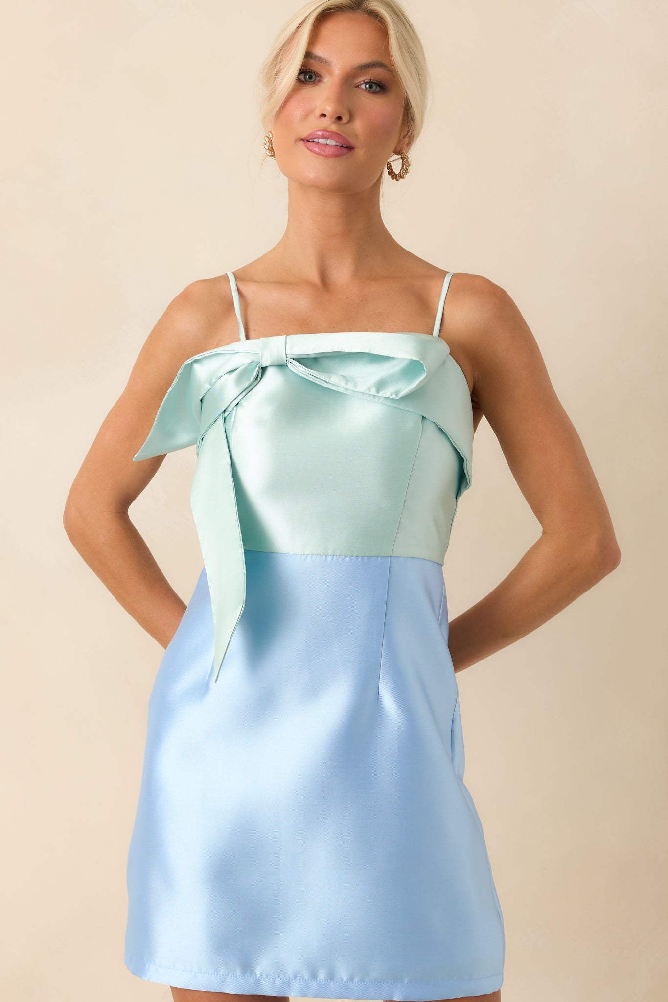 Cropped shot focusing on the upper bodice, showcasing the square neckline, bow detail, and adjustable spaghetti straps.