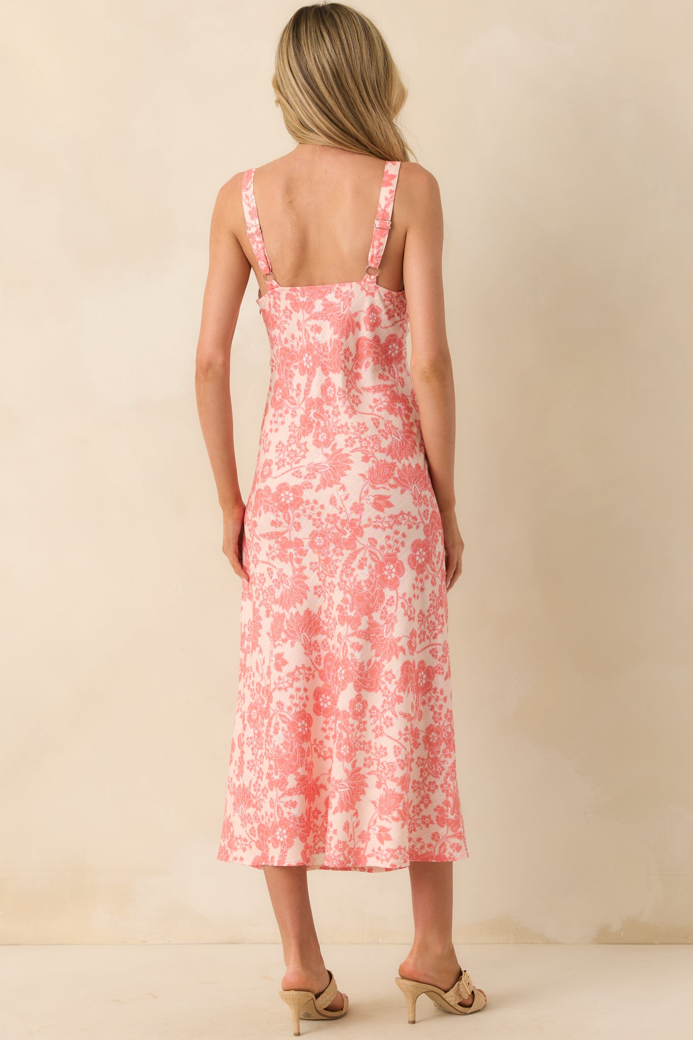 Back view of the dress highlighting the wide adjustable straps, smooth back panel, and continuation of the floral print.
