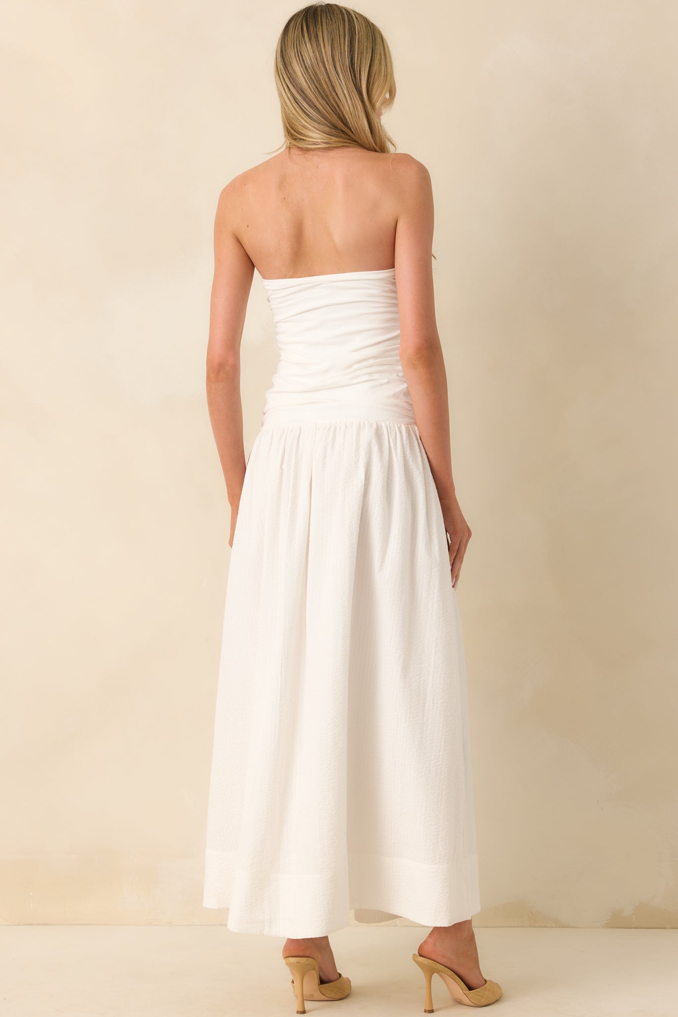 Back view of the dress showing the continuation of the ruched bodice and the flow of the fully lined seersucker skirt.