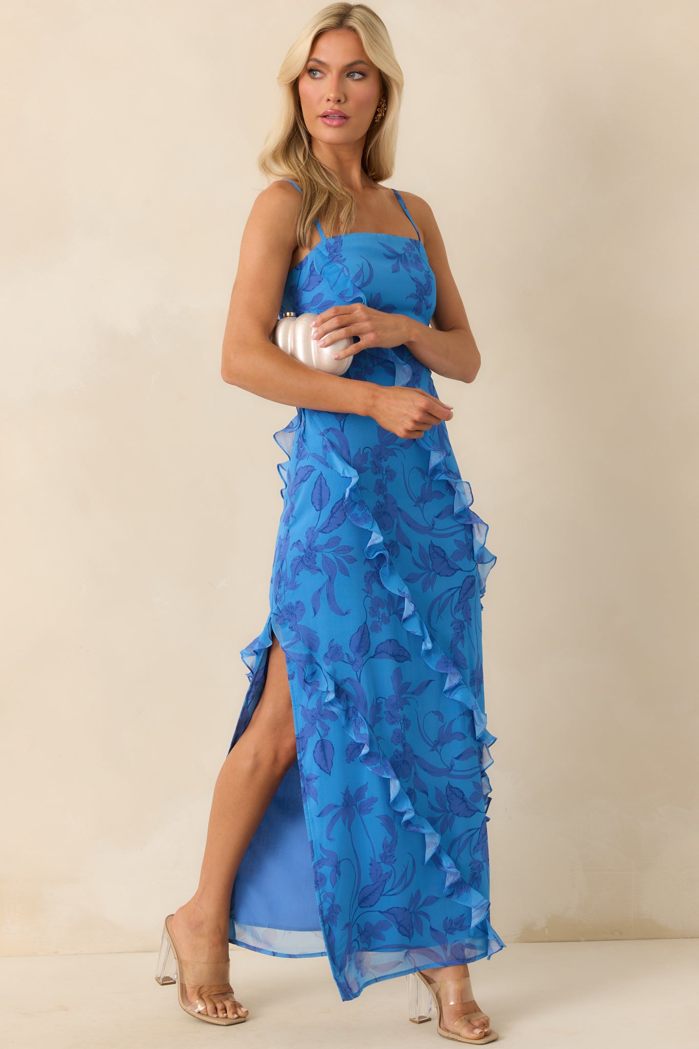 Full body front view of the blue maxi dress featuring a violet floral print, square neckline, and adjustable spaghetti straps.