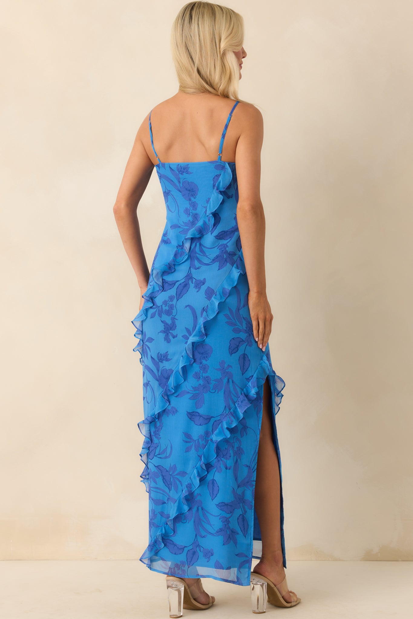Back view of the dress showing the adjustable straps, fitted bodice structure, and continuation of the floral print and ruffles from behind.