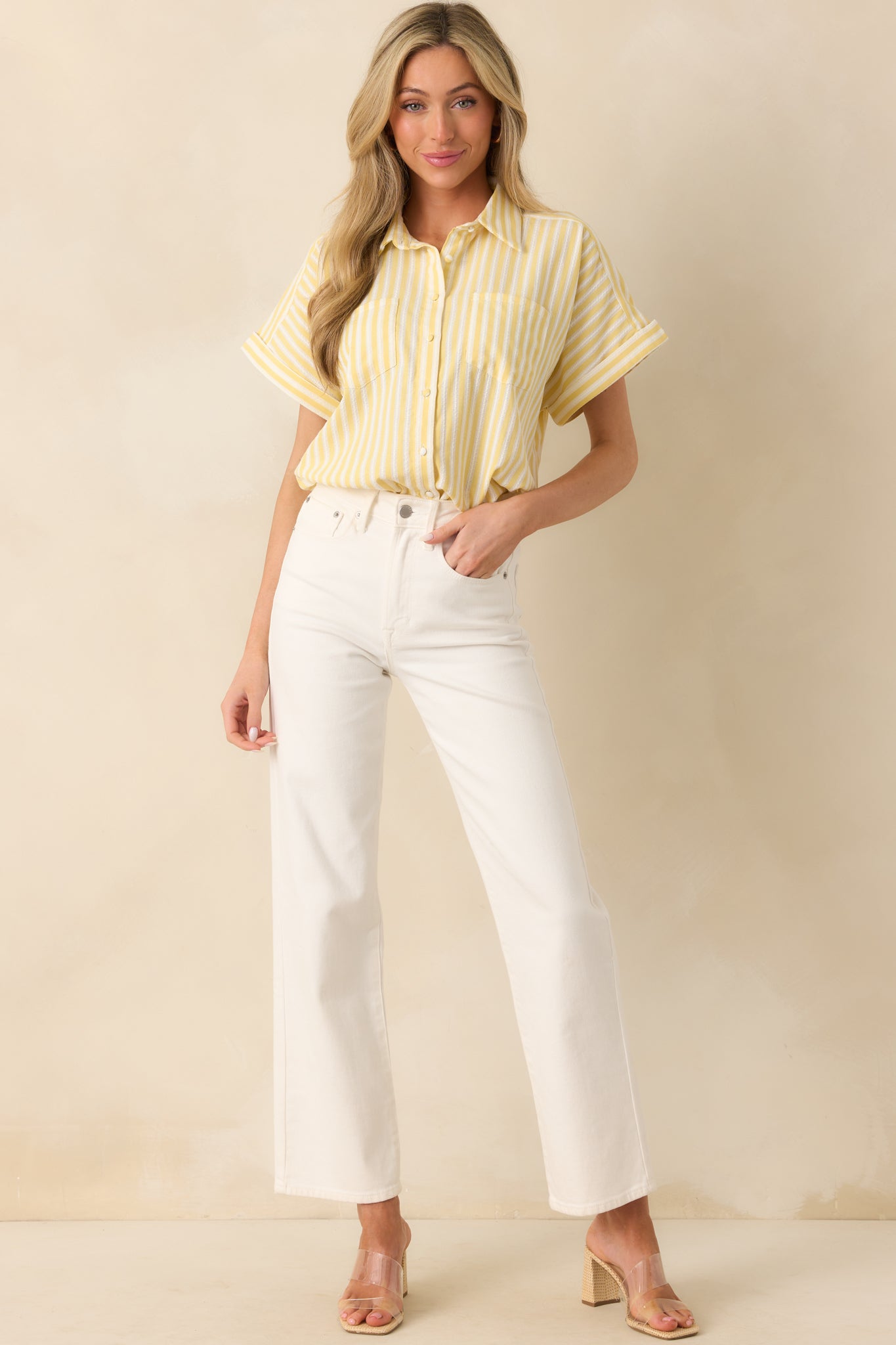 Striped high-low hem shirt featuring short cuffed sleeves and functional breast pockets, displayed in a full-body shot.