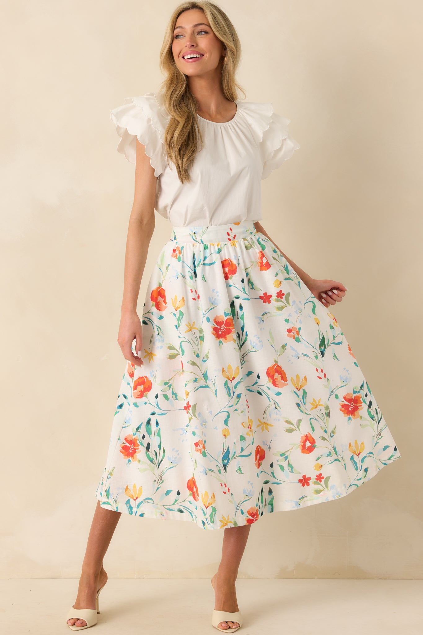 Ivory midi skirt with Prosperina multicolor floral print and high-rise fit, shown full-length to display its flow and shape.