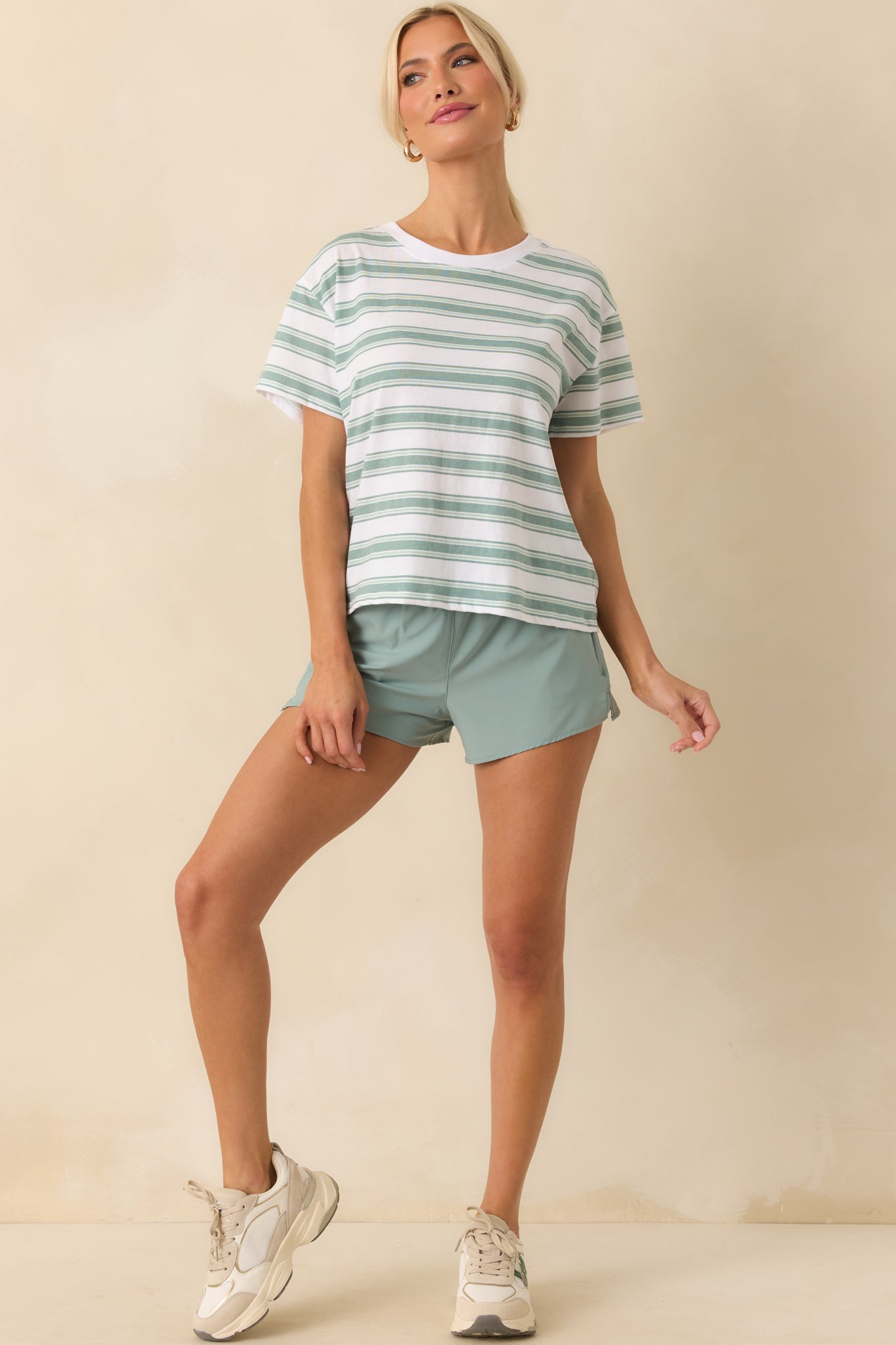 Full body view of the green tee showing its relaxed fit and lightweight cotton drape.
