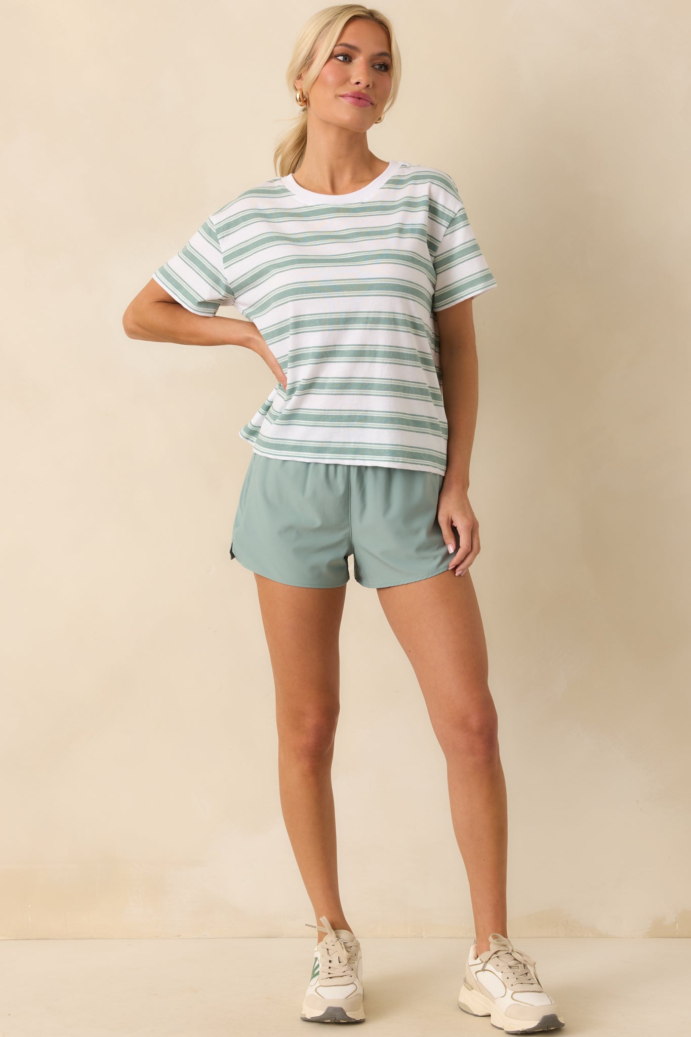 Angled full body view highlighting the regular fit and subtle side seam vent slit on one leg.