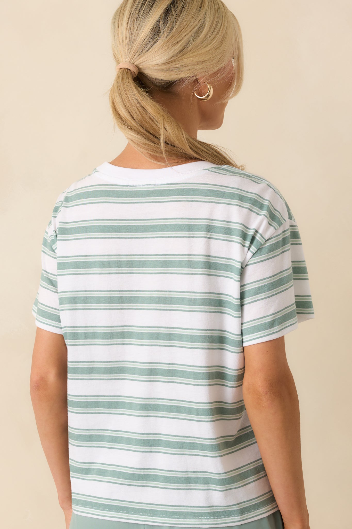 Rear view of the tee displaying the uninterrupted green and white stripes and overall relaxed fit.