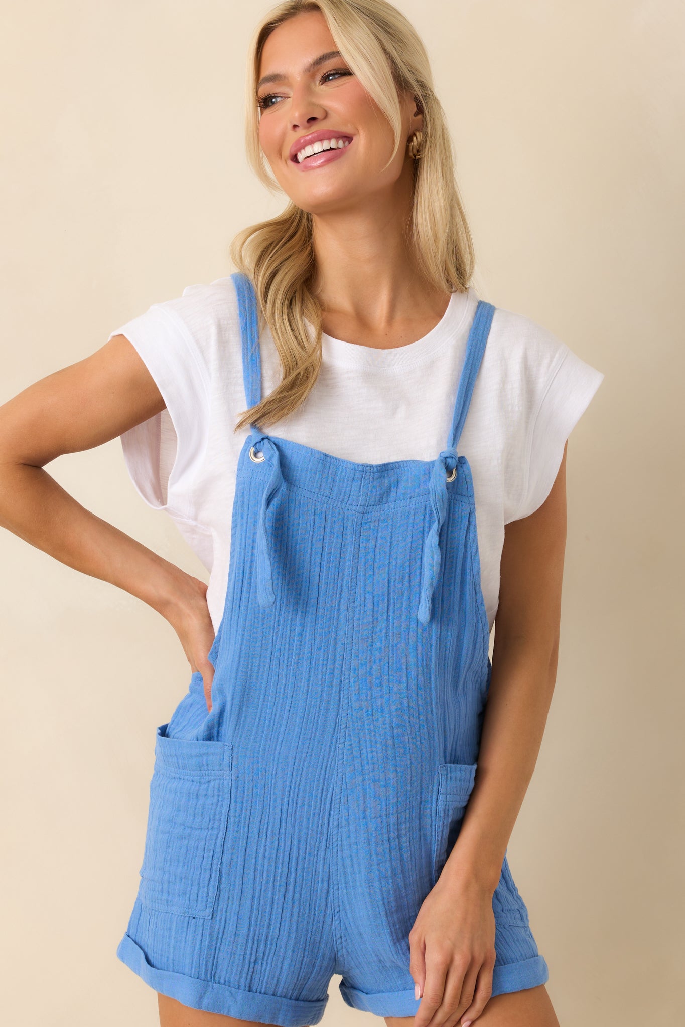 Cropped view from the chest down, focusing on the textured gauze fabric and square neckline.