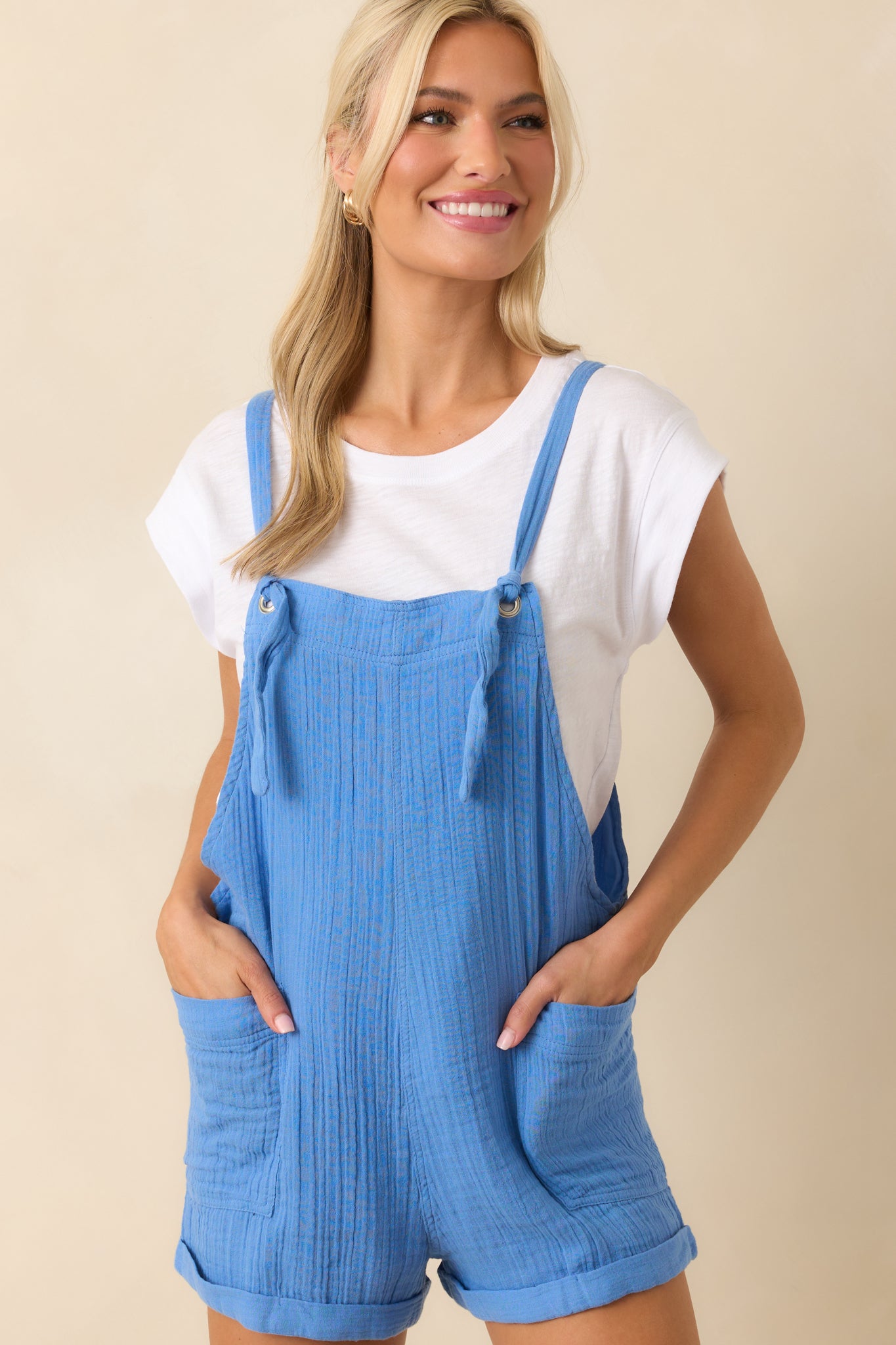 Cropped upper view emphasizing the tied shoulder straps and lightweight cotton fabric.