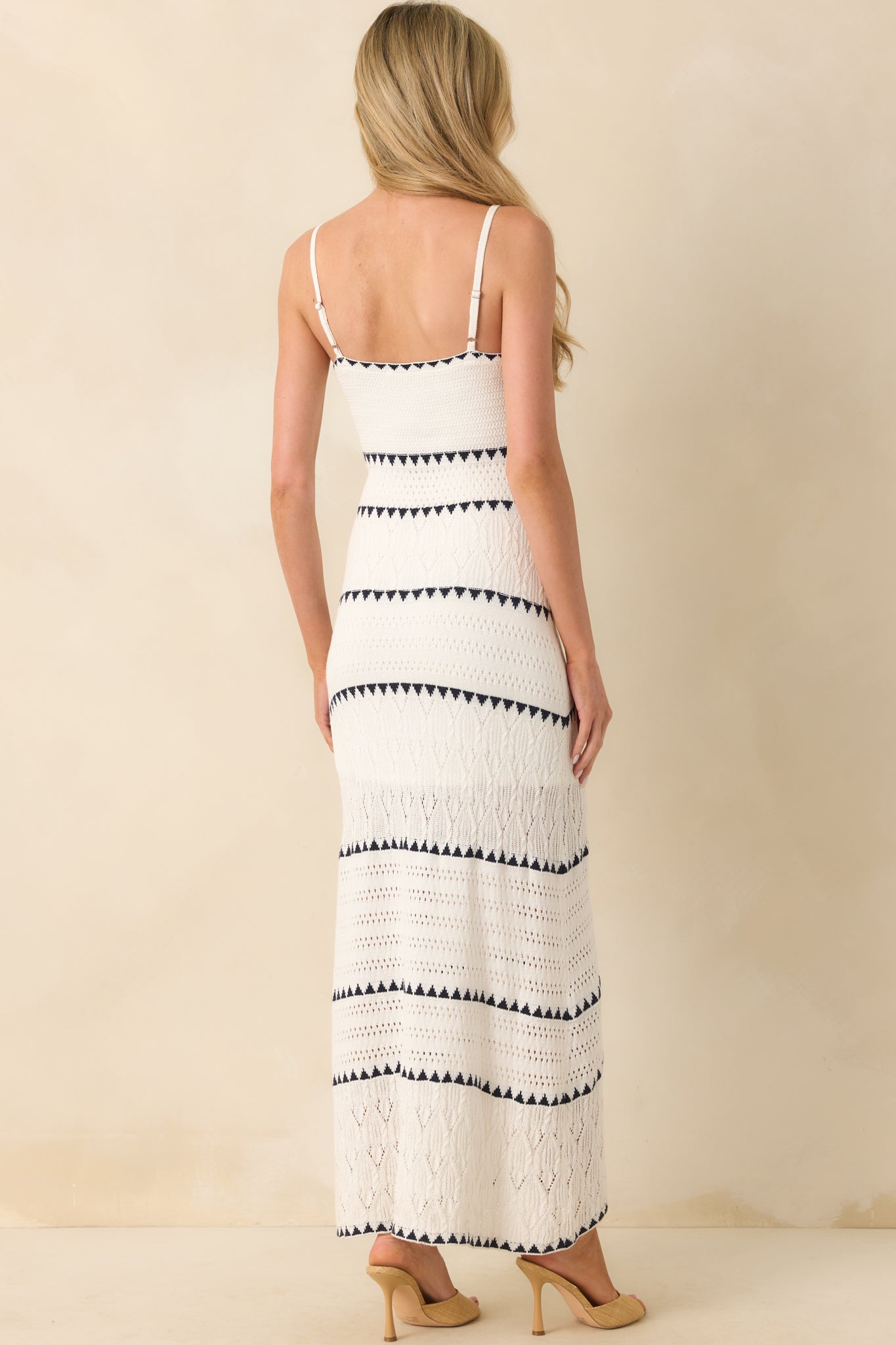 Back view of the dress featuring the adjustable straps, low scoop back, and continued navy stripe design over the crochet knit.
