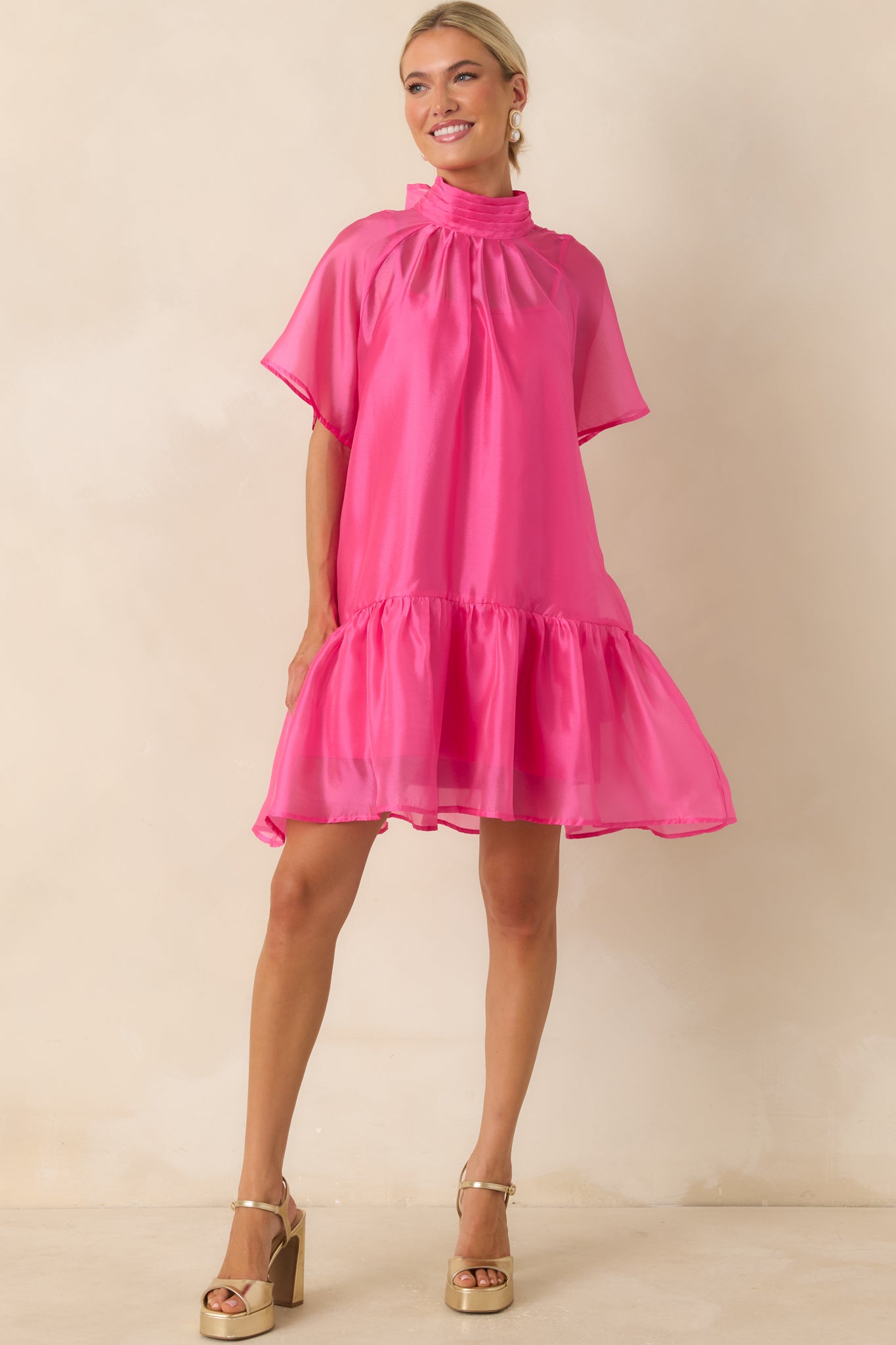 Pink ethereal mini dress with a flowy shift shape, delicate sheer sleeves, and airy layered organza finish.