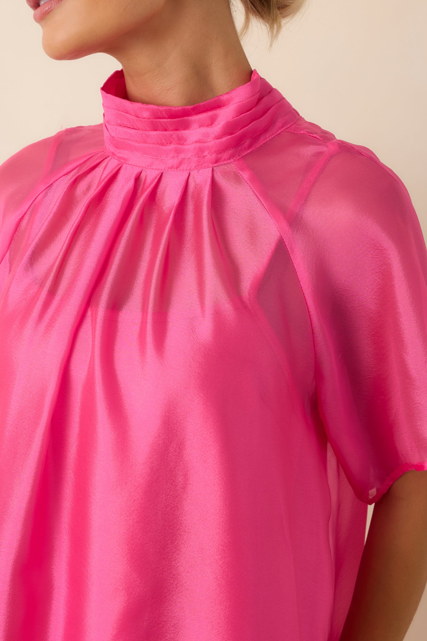 Close-up of the pink organza fabric highlighting its sheer, lightweight texture, ruffled hem construction, and soft drape.