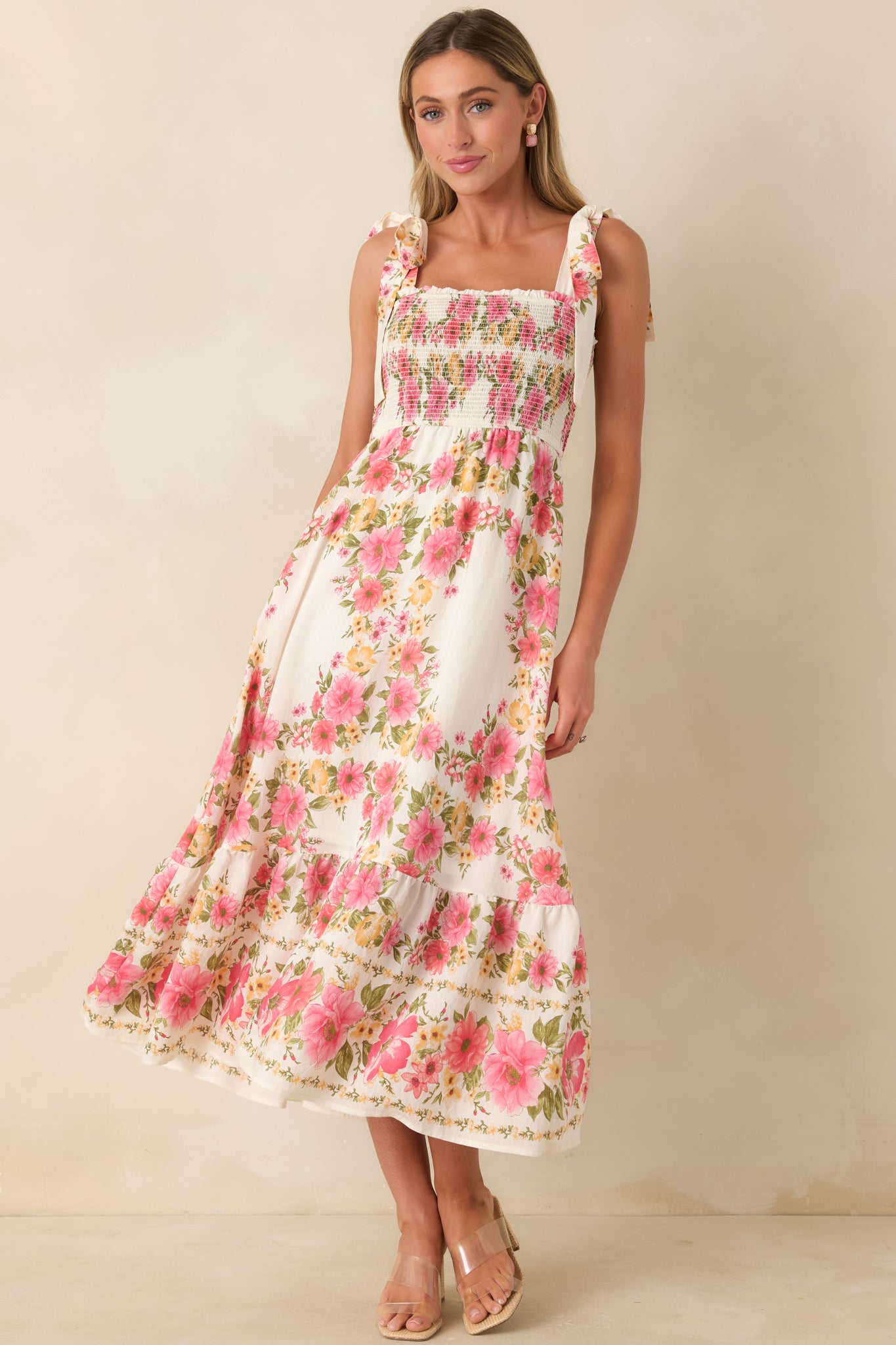 Floral midi dress featuring adjustable tie straps and soft, airy fabric movement.