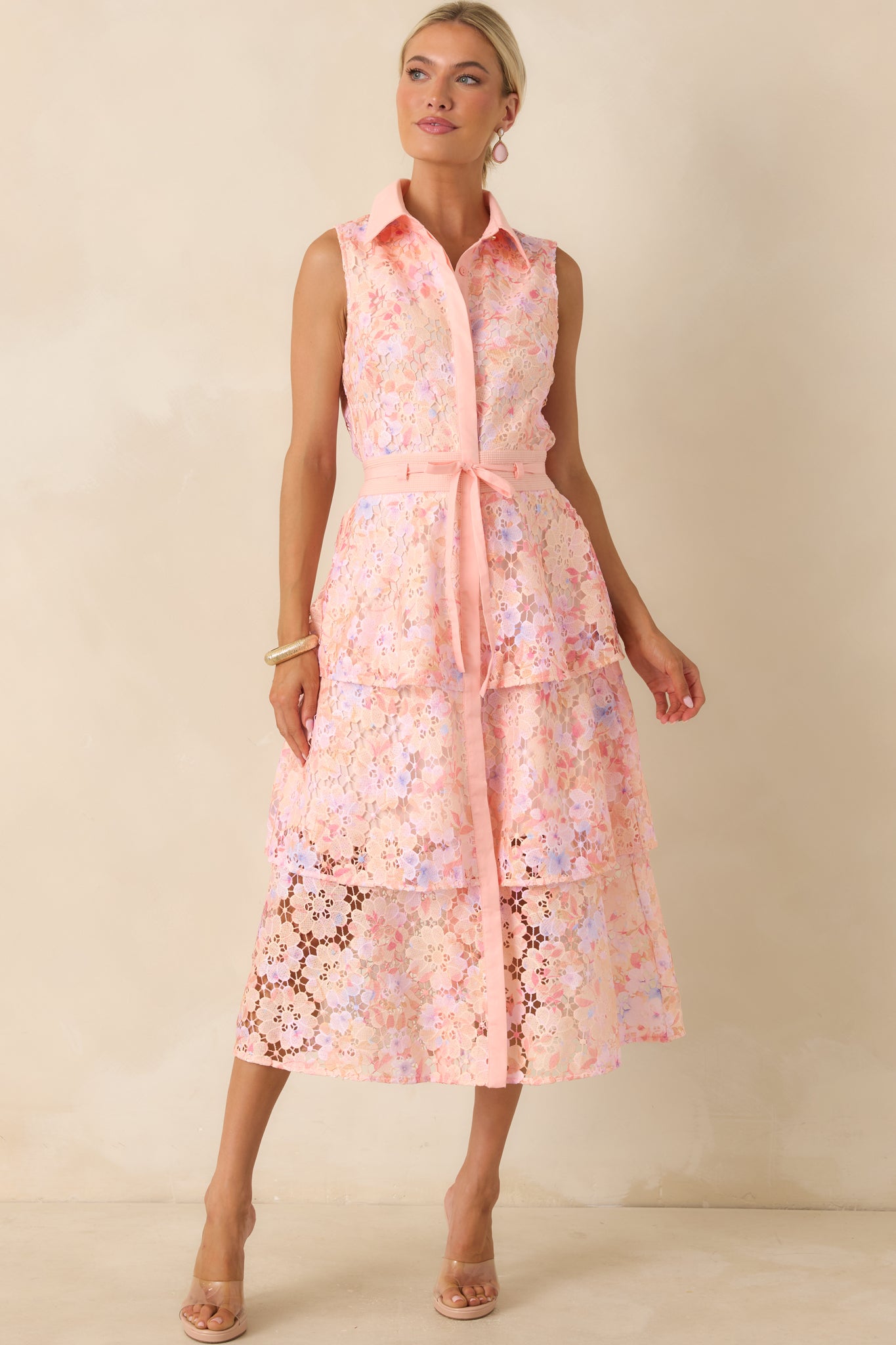 Pink floral lace dress with a flowing tiered skirt and timeless button-front design in a midi length.