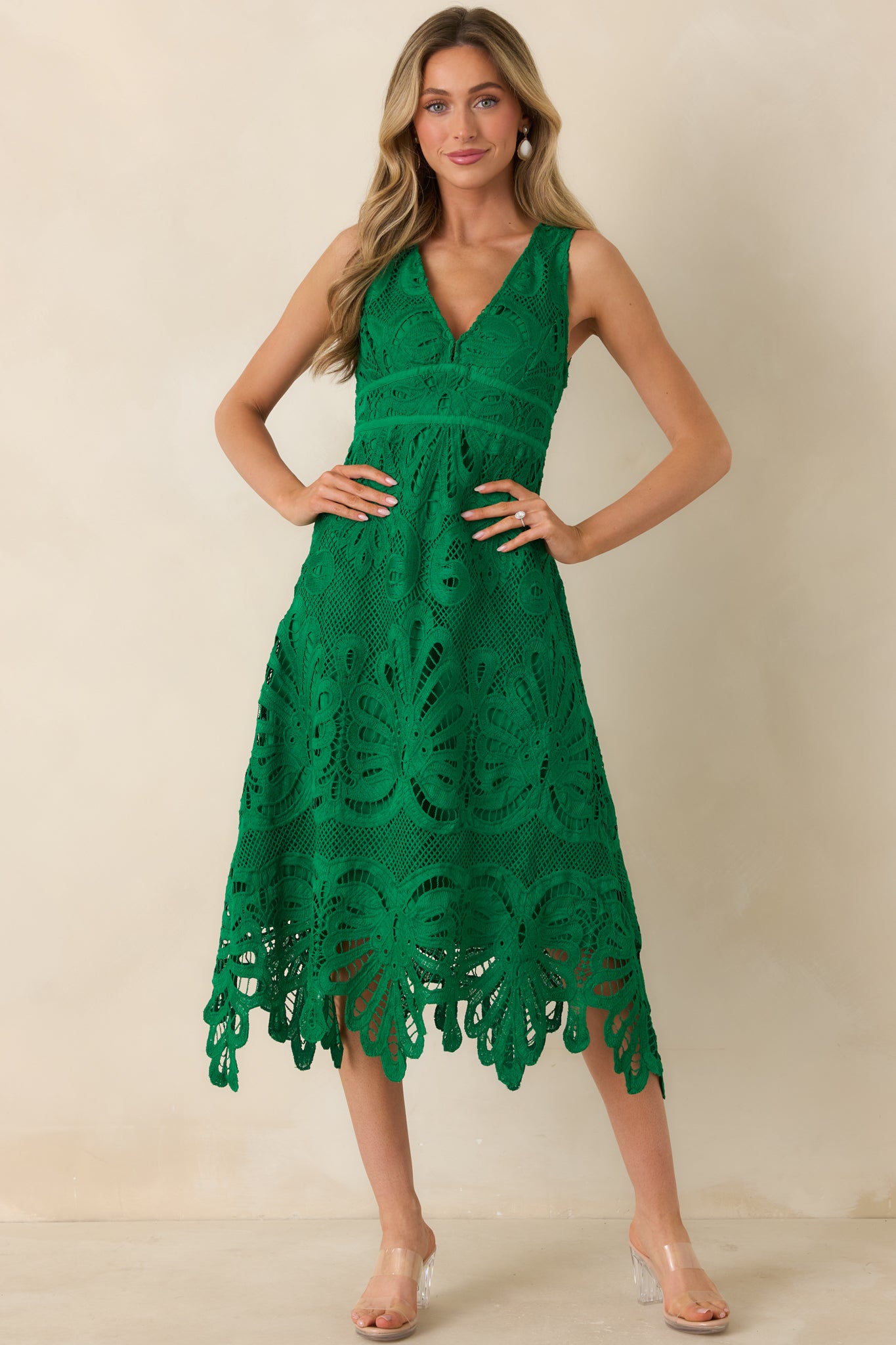 Lace midi dress in rich green with a structured bodice and detailed skirt.