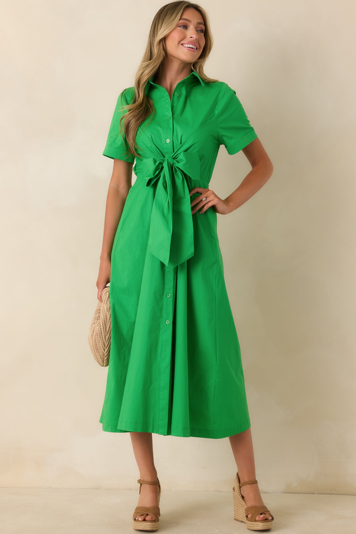Green midi dress showcasing side pockets, a structured collar, and a polished yet playful silhouette.