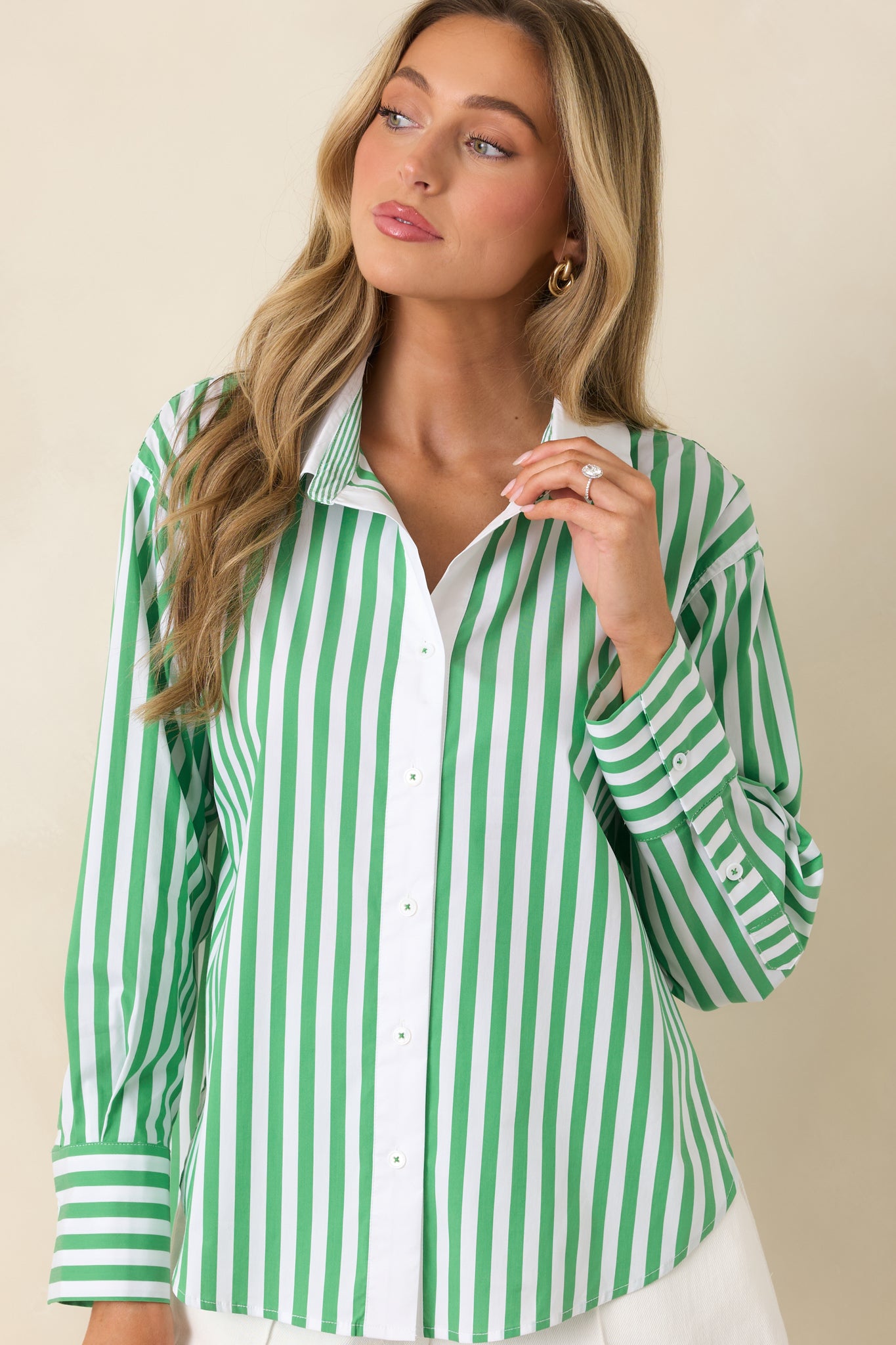 Striped top showcasing the bold pattern and structured collar detail.