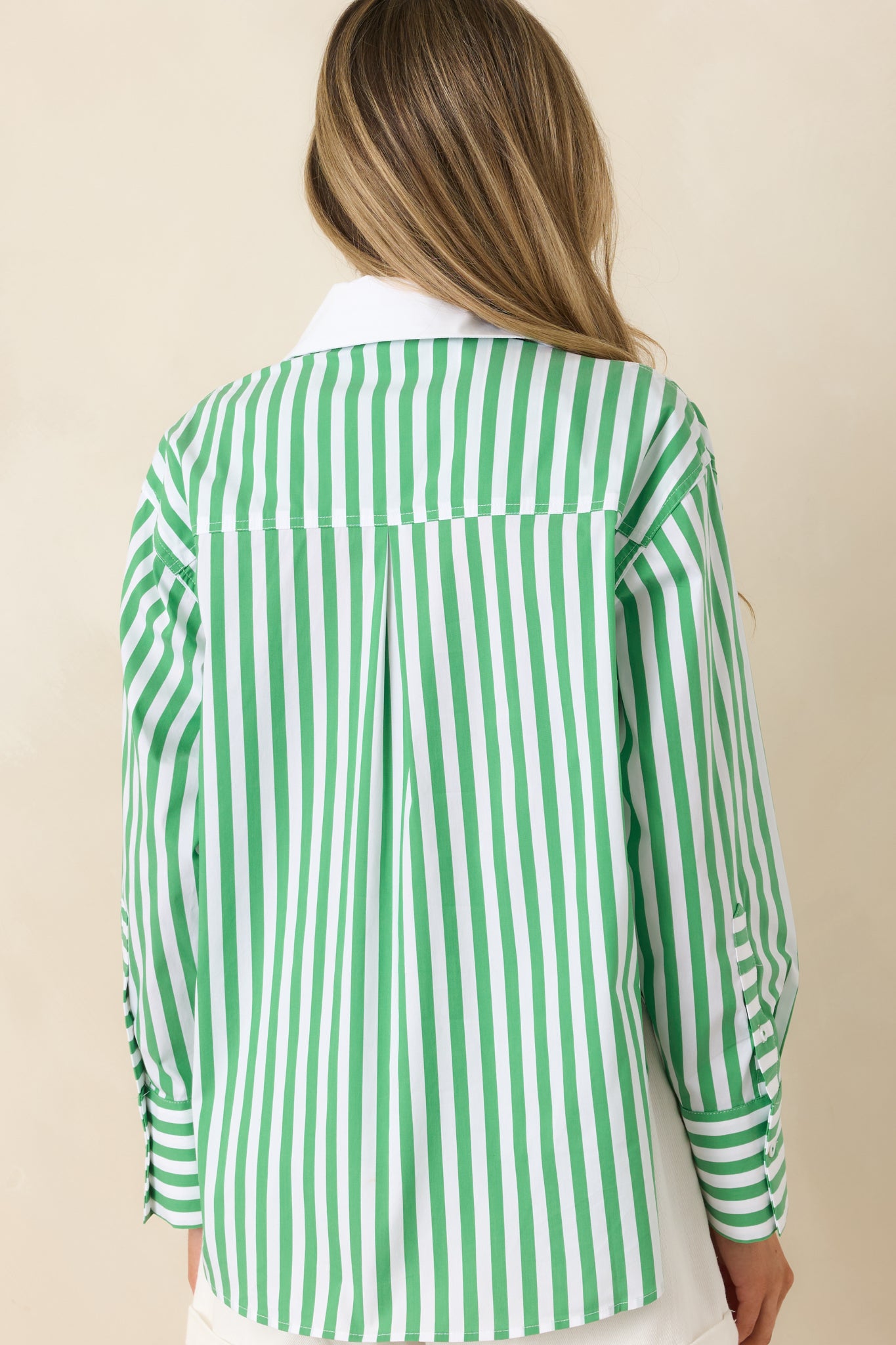 Rear view of the green and ivory striped shirt with a relaxed silhouette.