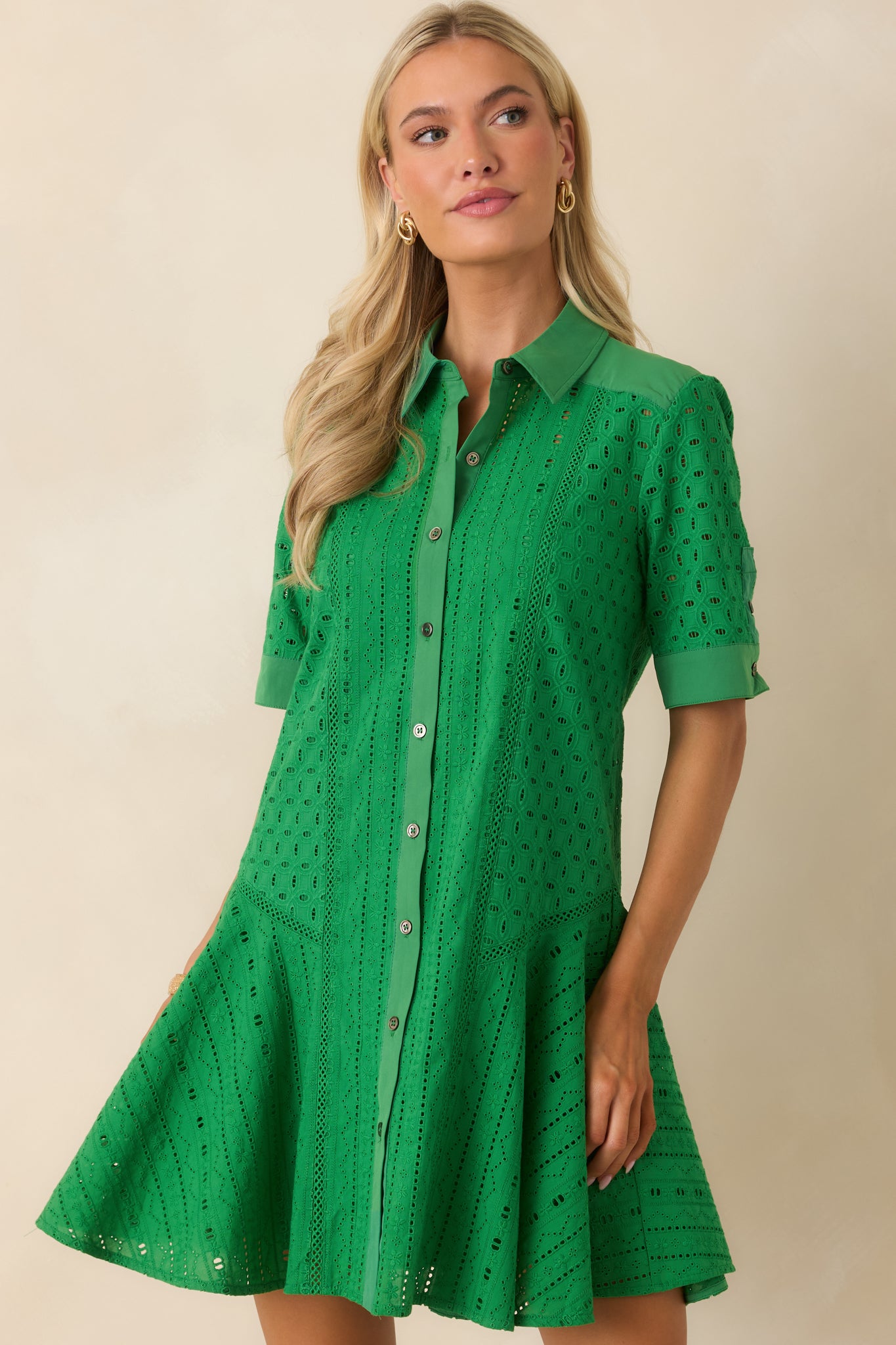 Front view of the green eyelet dress highlighting the collared neckline and button-front closure.