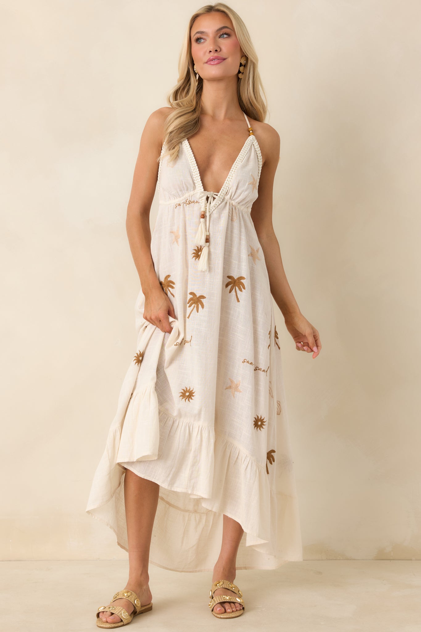 Beige gauze dress with adjustable tie accents and bead detailing at neckline.