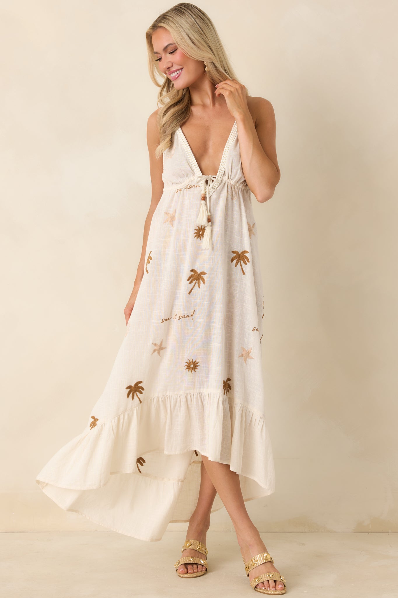Light beige dress with soft embroidered pattern and elegant midi-length hem.