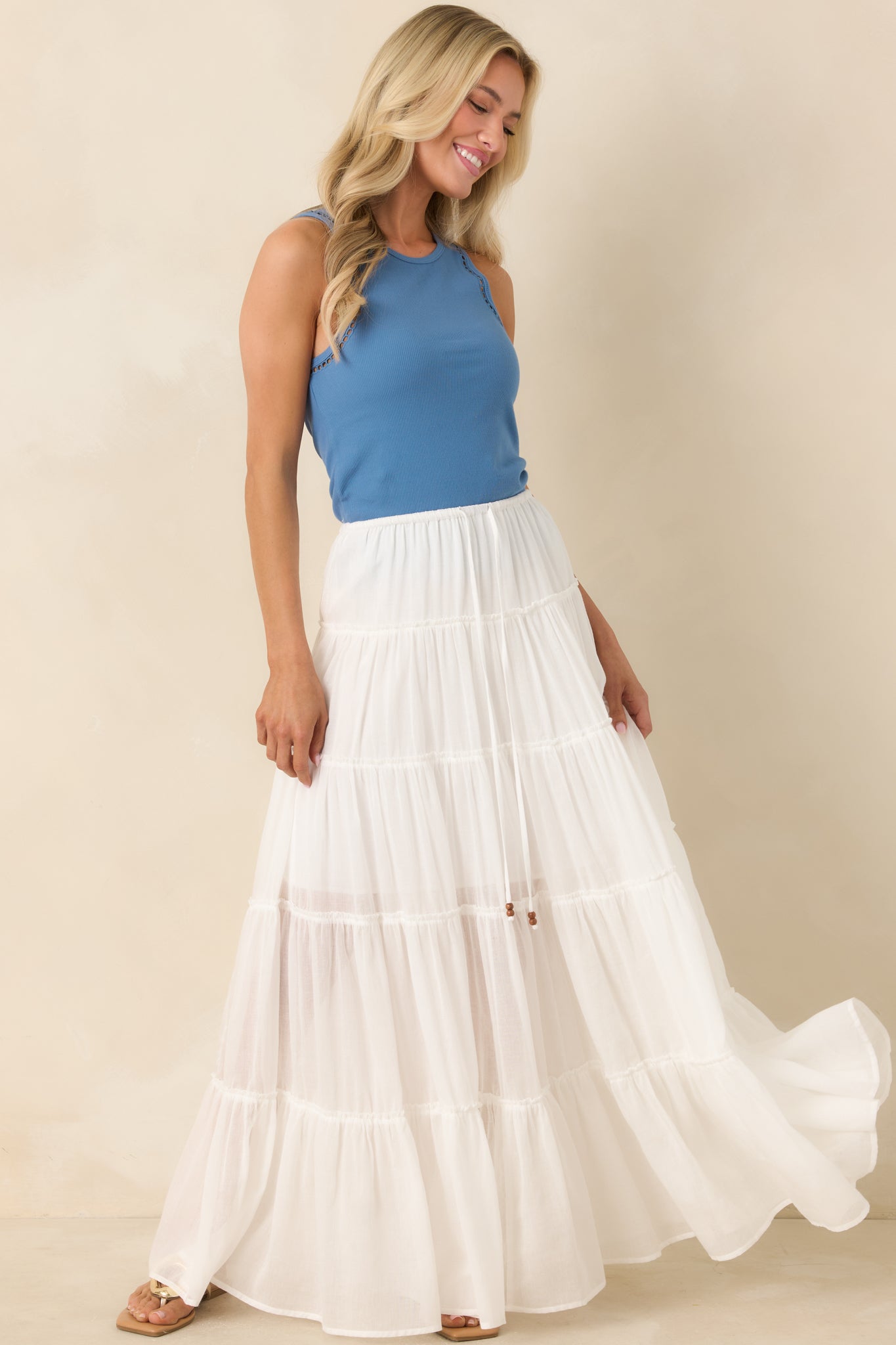 Soft cotton rib top featuring sleeveless cut, textured trim, and clean fitted shape.