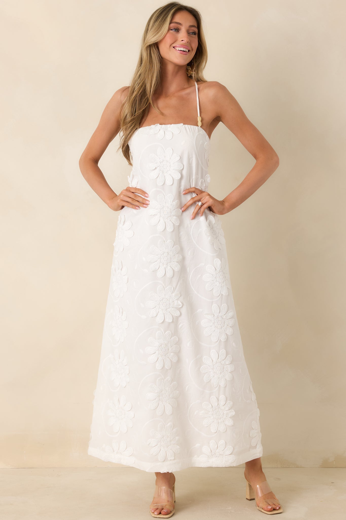 Front-facing view emphasizing delicate floral appliqué details and minimal styling on the bodice.