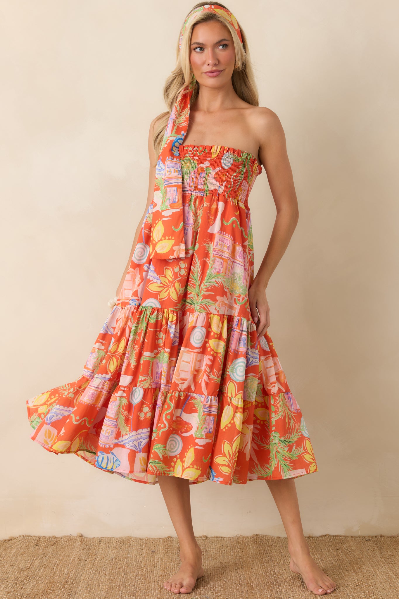 Orange multi convertible skirt dress featuring a smocked elastic bodice, tiered midi-length silhouette, and lightweight 100% cotton fabric.