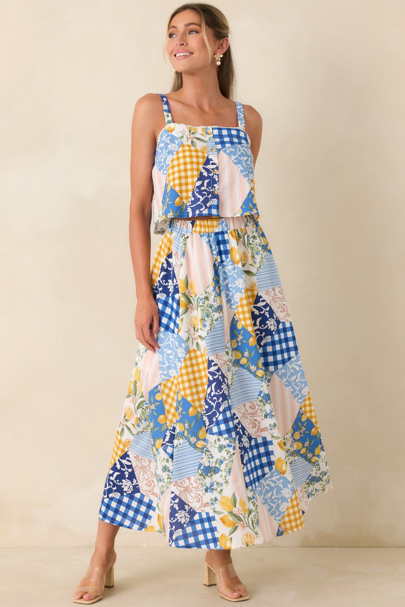 Lightweight cropped top featuring mixed blue patchwork print and adjustable shoulder straps.