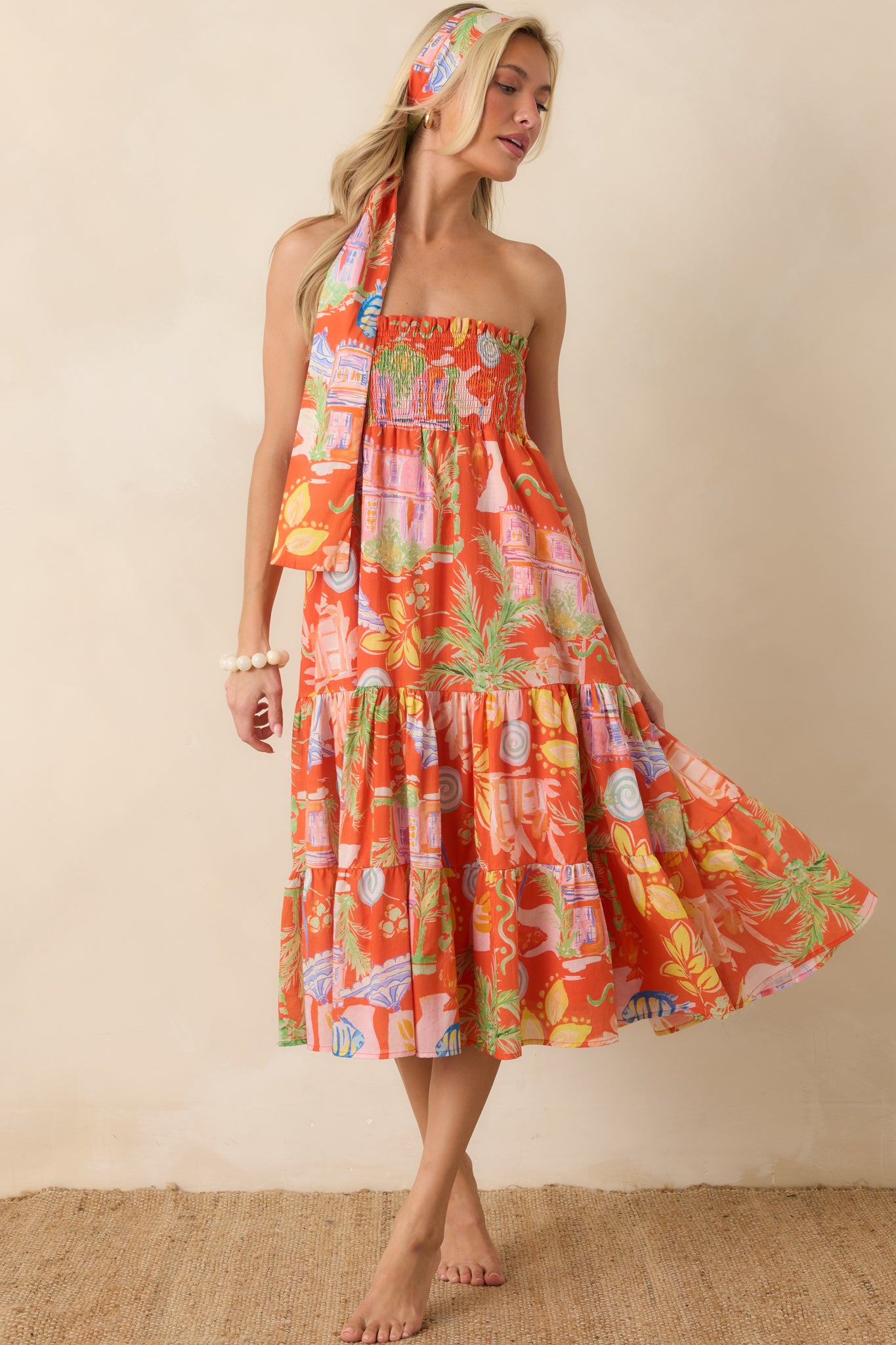 Convertible midi dress highlighting a smocked upper section, gathered tiers, and lightweight fabric with fluid drape.