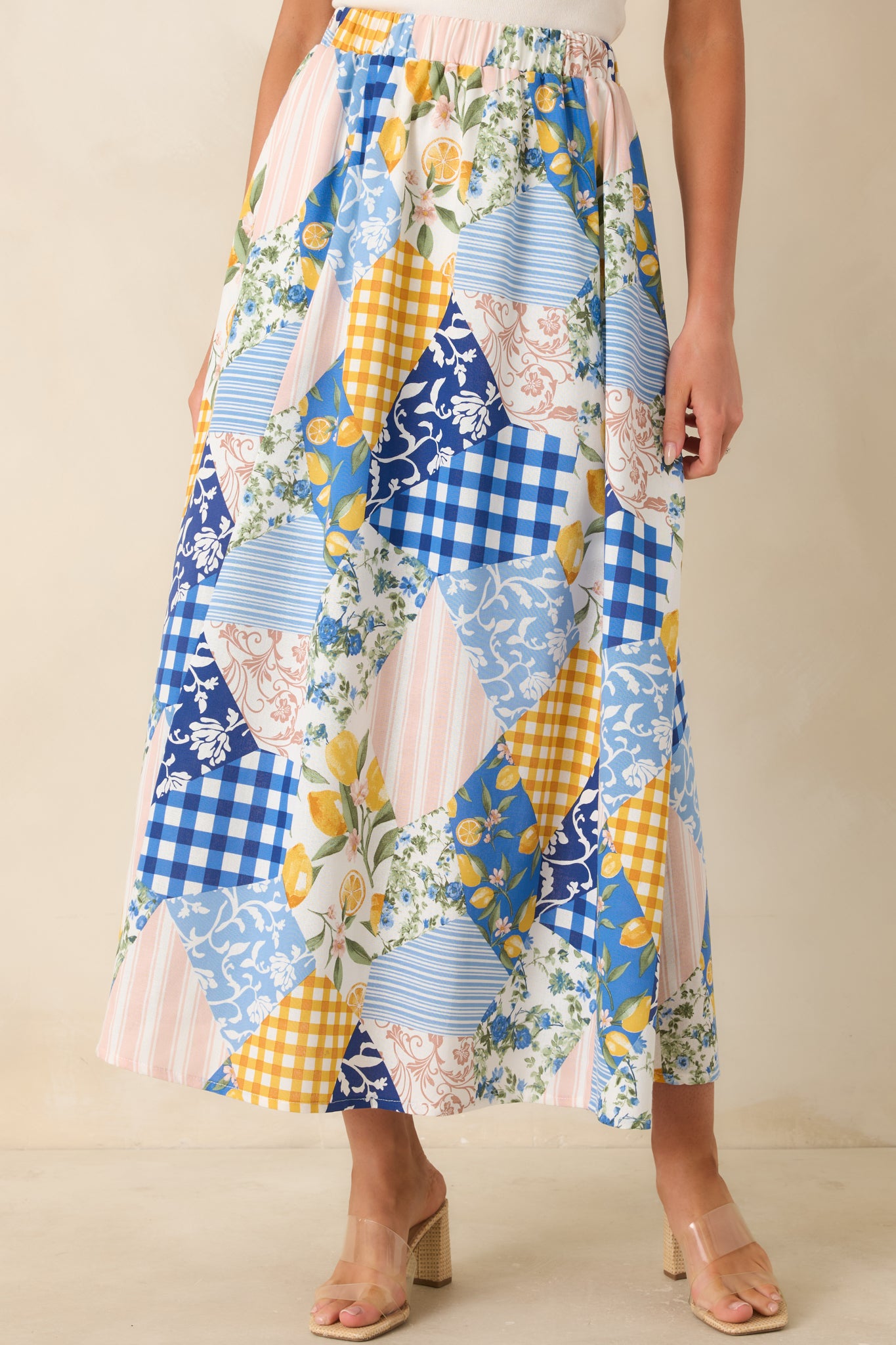 Side pocket detail on multi-print midi skirt with relaxed silhouette.