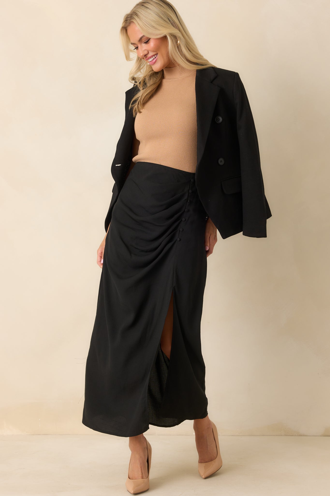 Front-facing full length image highlighting the padded shoulders and overall tailored fit of the blazer.