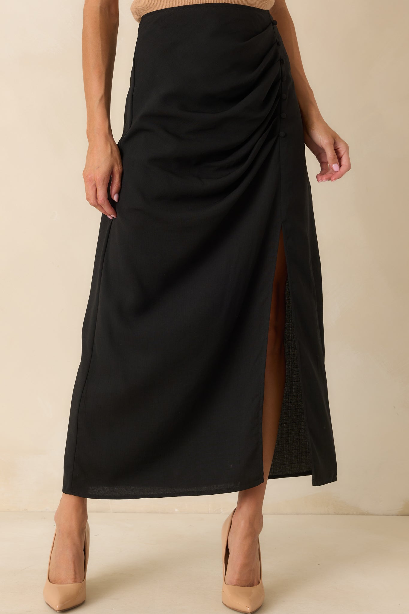 A cropped front view focusing on the high waist and placement of the faux buttons along the front seam.