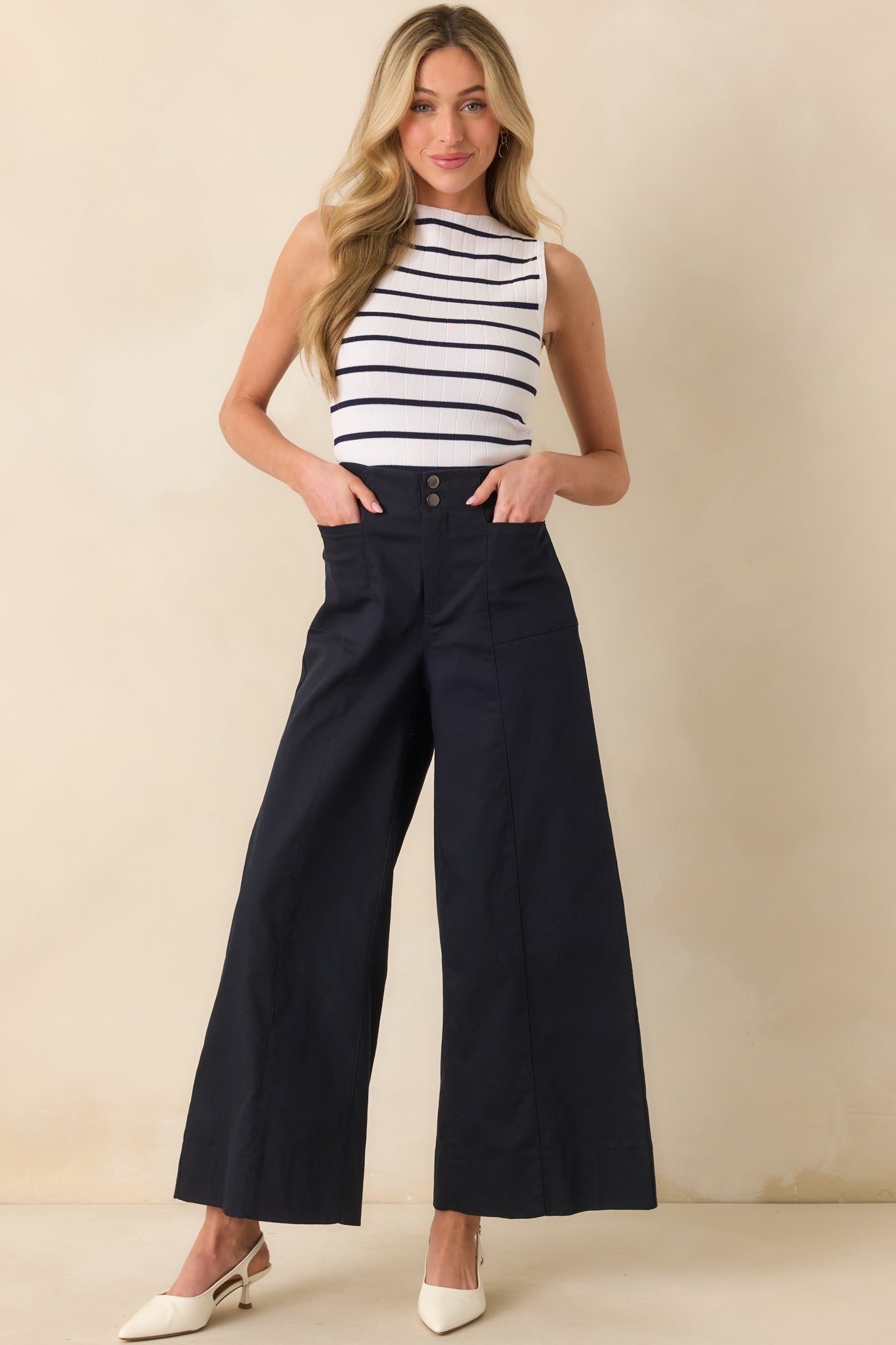 Full body image highlighting the structured shape and hip pocket placement on the navy pants.