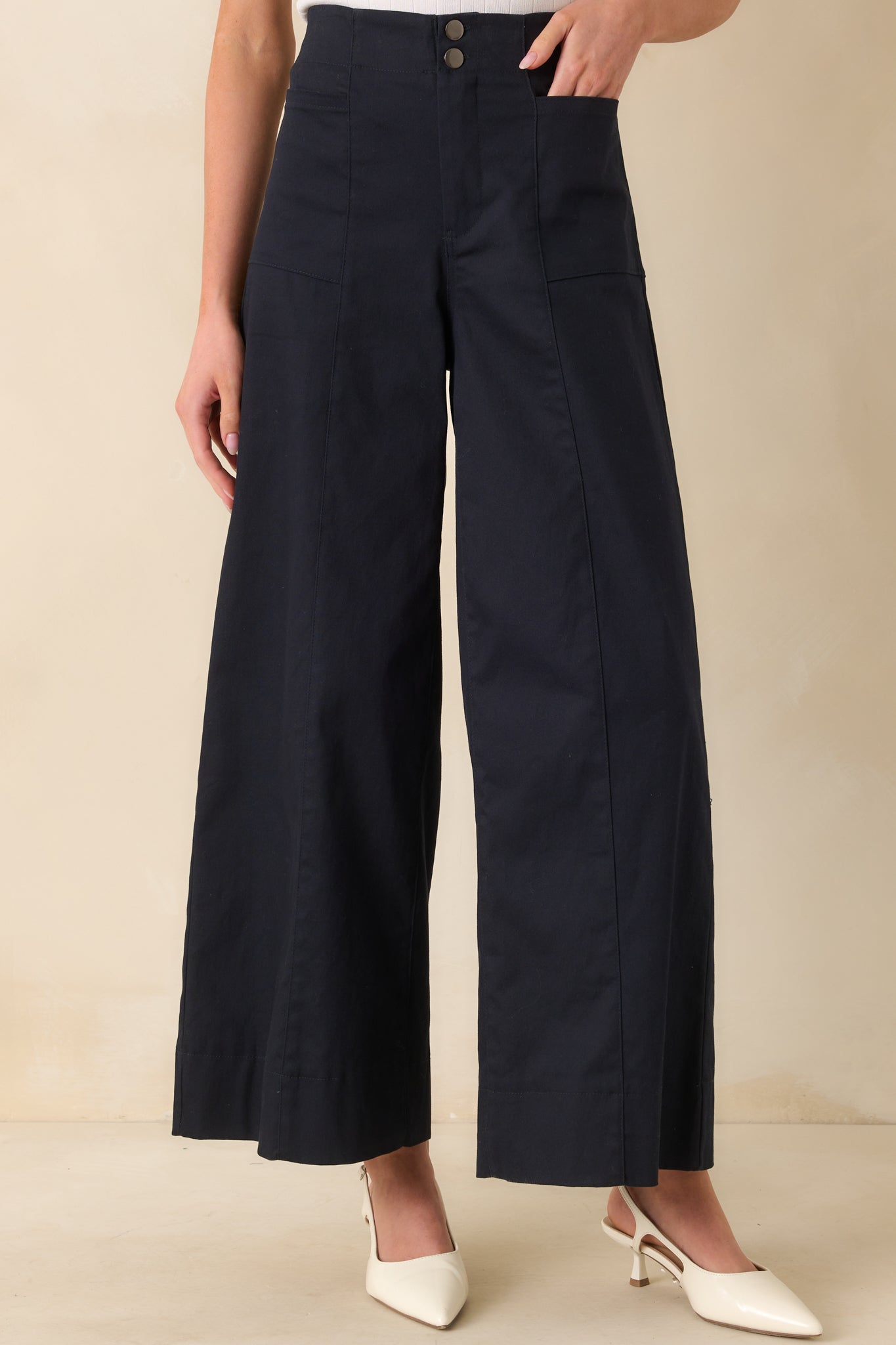 Close-up of the upper legs and waistband, highlighting the tailored seams and smooth fabric.