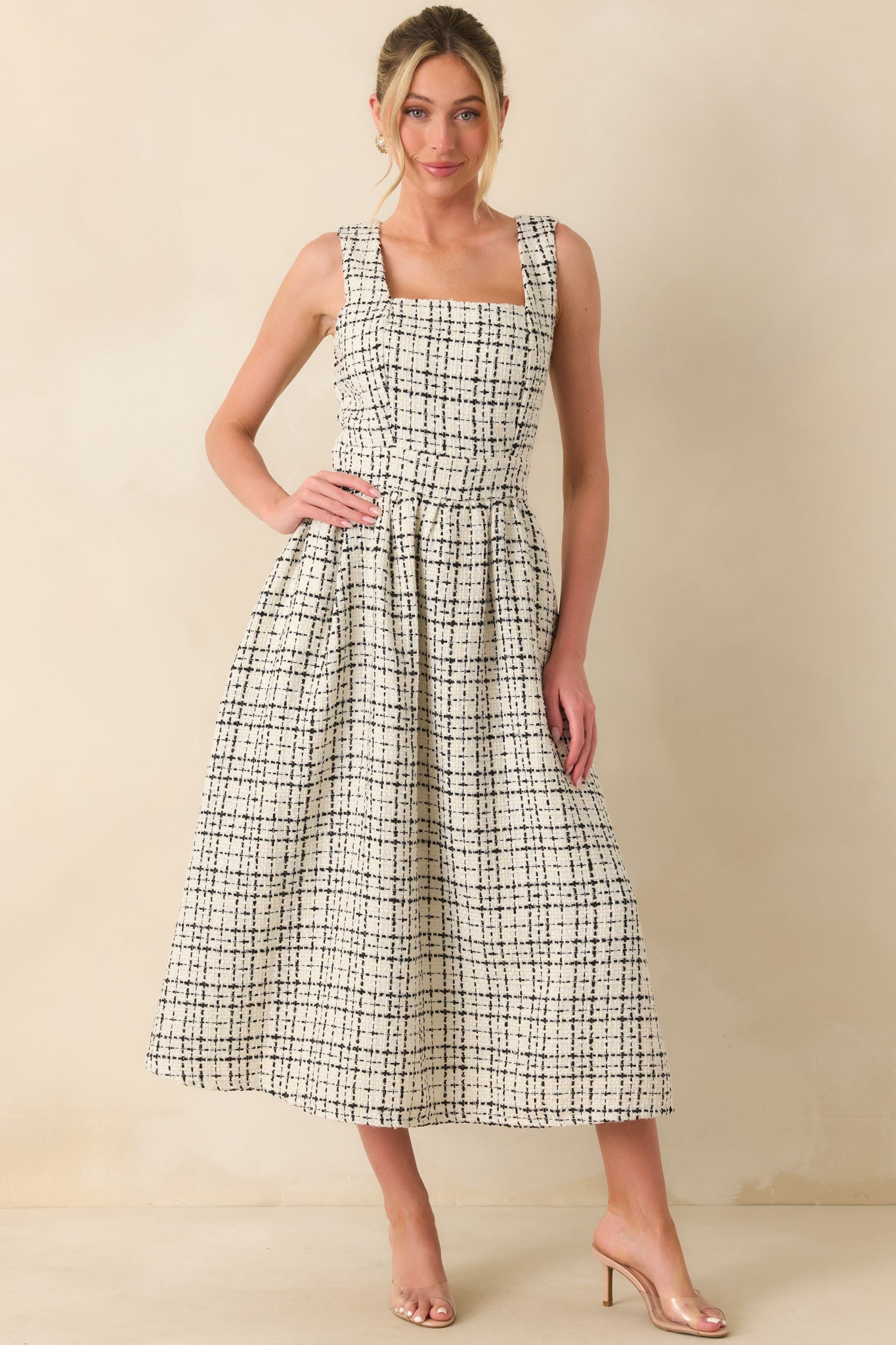 A straight-on view emphasizing the structured square neckline and fitted bodice.