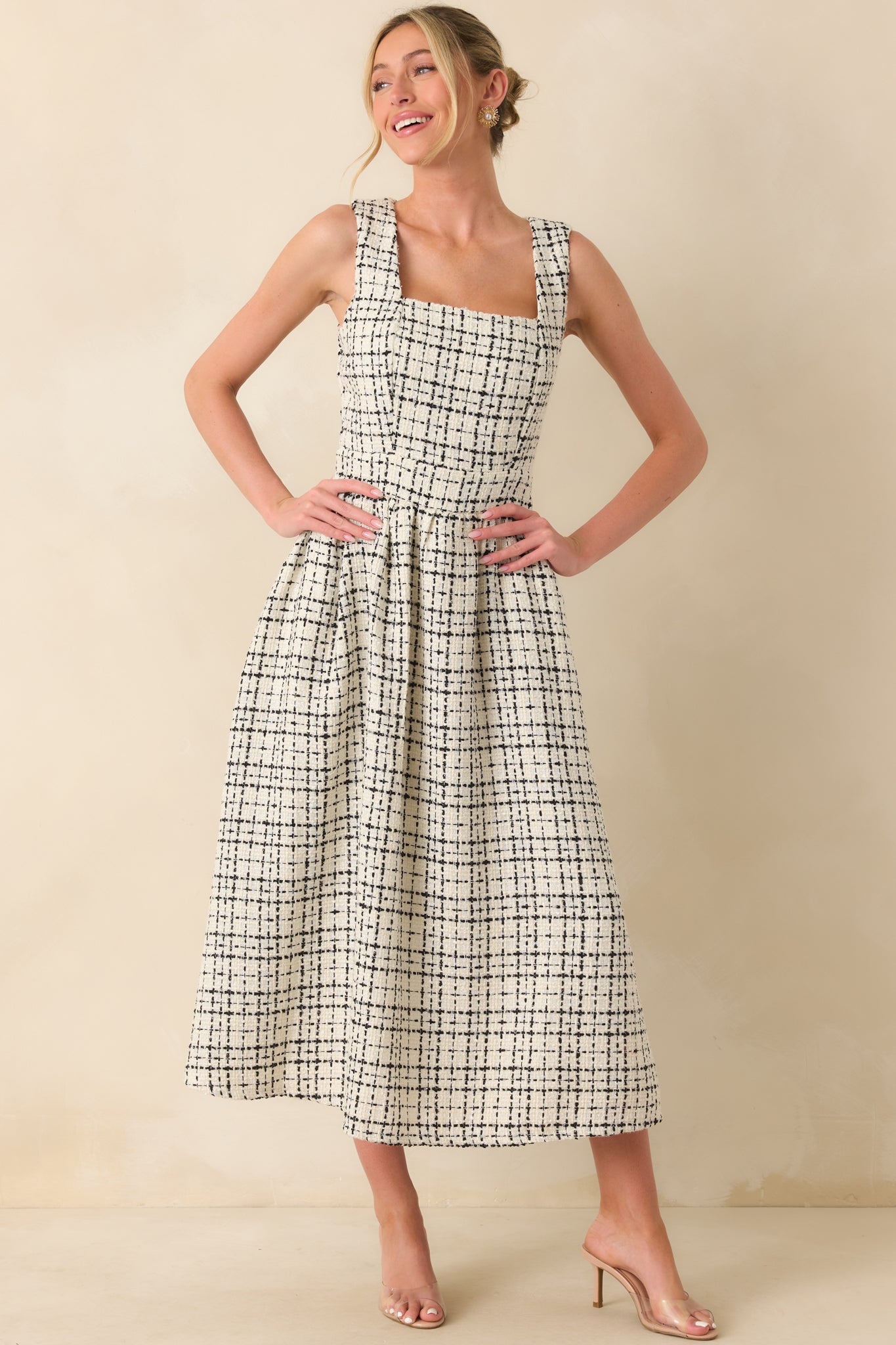 A front view of the white and black tweed midi dress with a square neckline, sleeveless cut, and fit-and-flare silhouette.