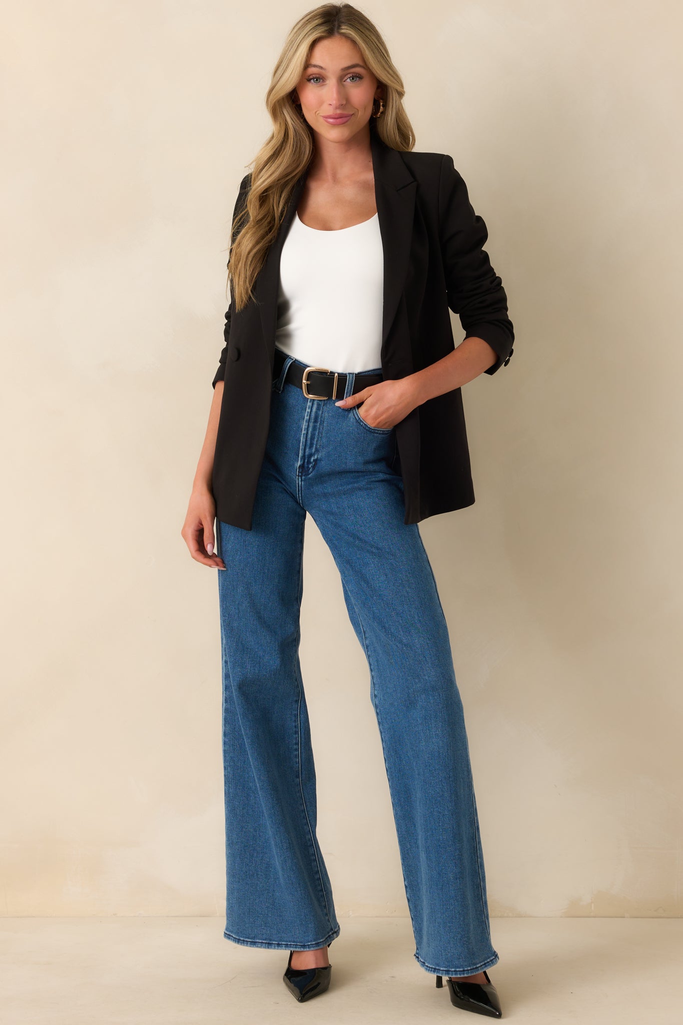 Full body front view of the black blazer highlighting its structured fit and lapel collar.