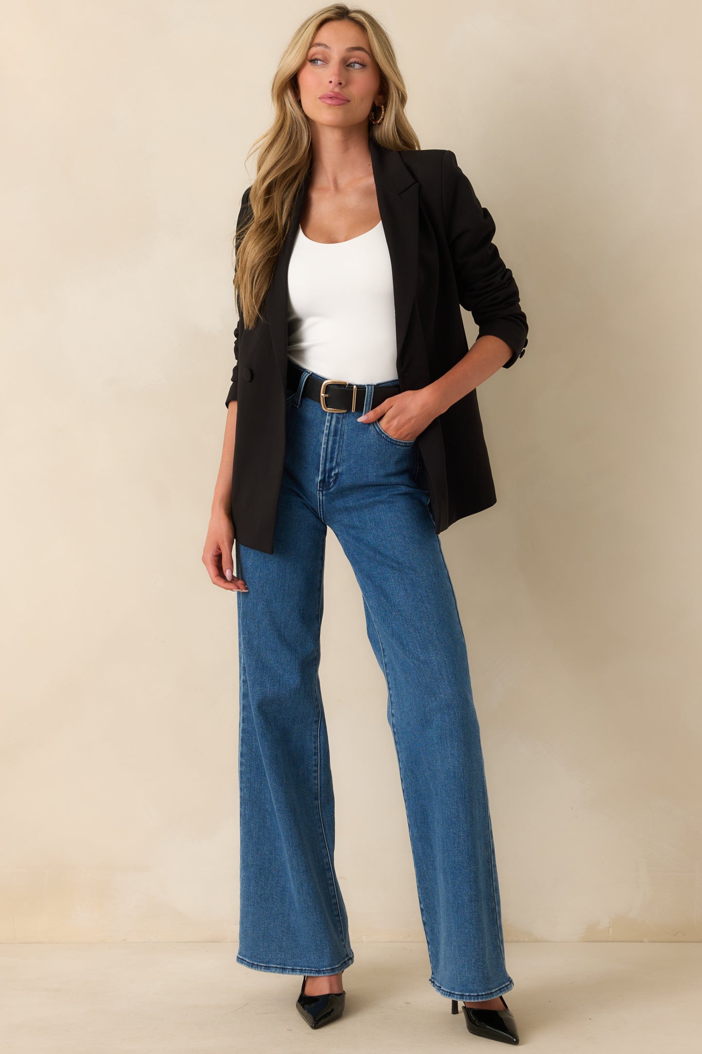 Full body side view capturing the clean lines of the blazer and lightweight shoulder pads.