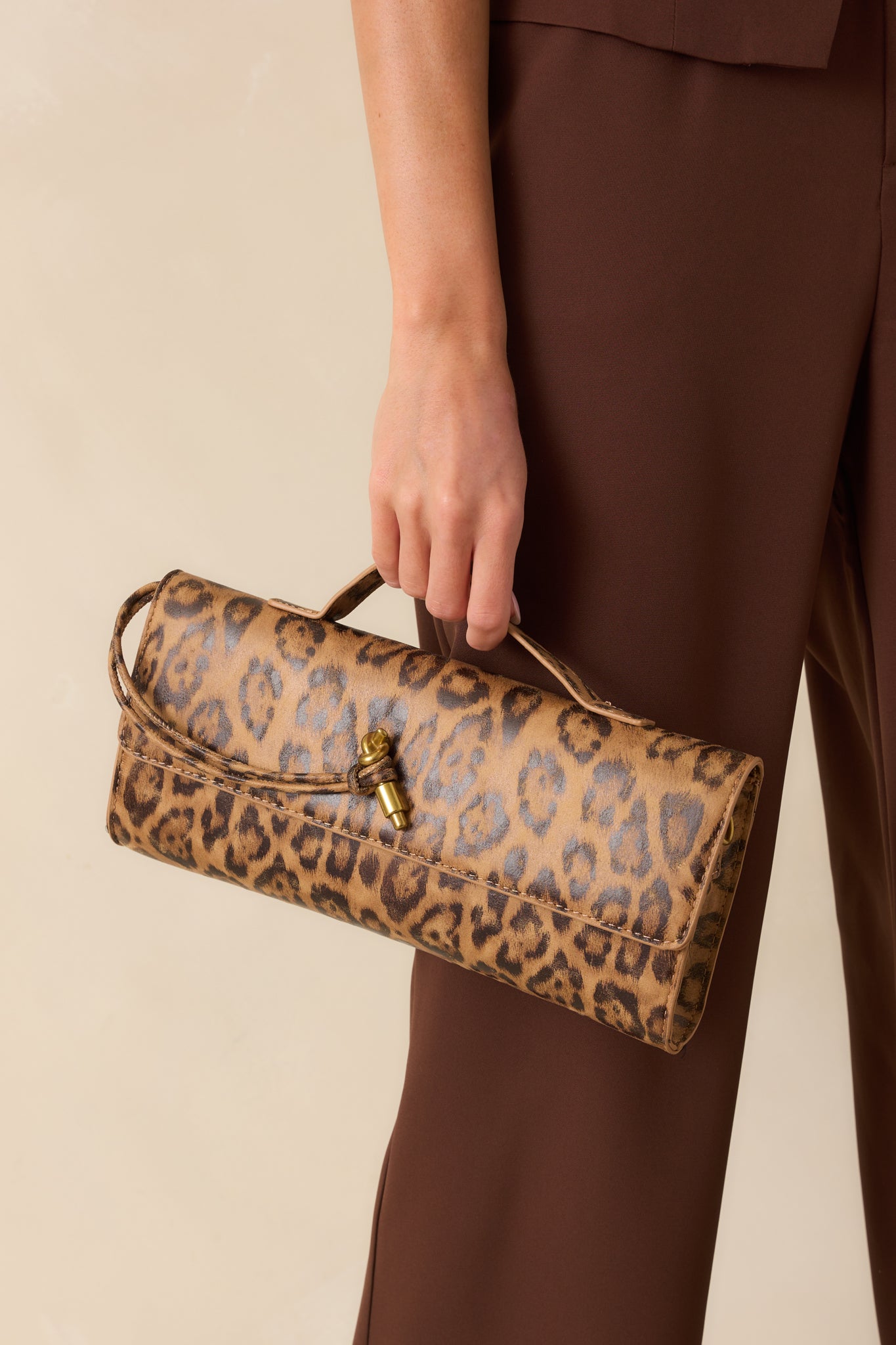 Close view showing the magnetic flap closure and bold leopard pattern.