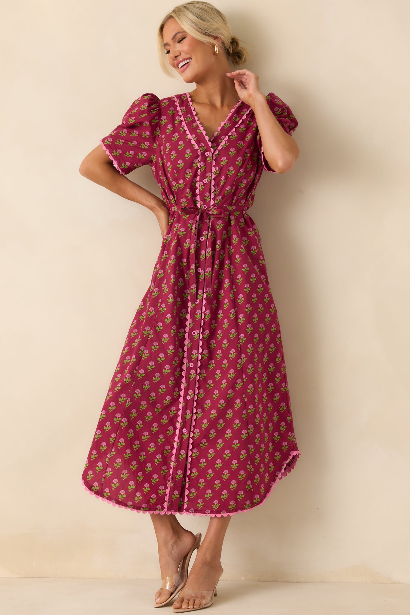 Full body front view of the burgundy maxi dress with a pink multicolor floral print and v-neckline.