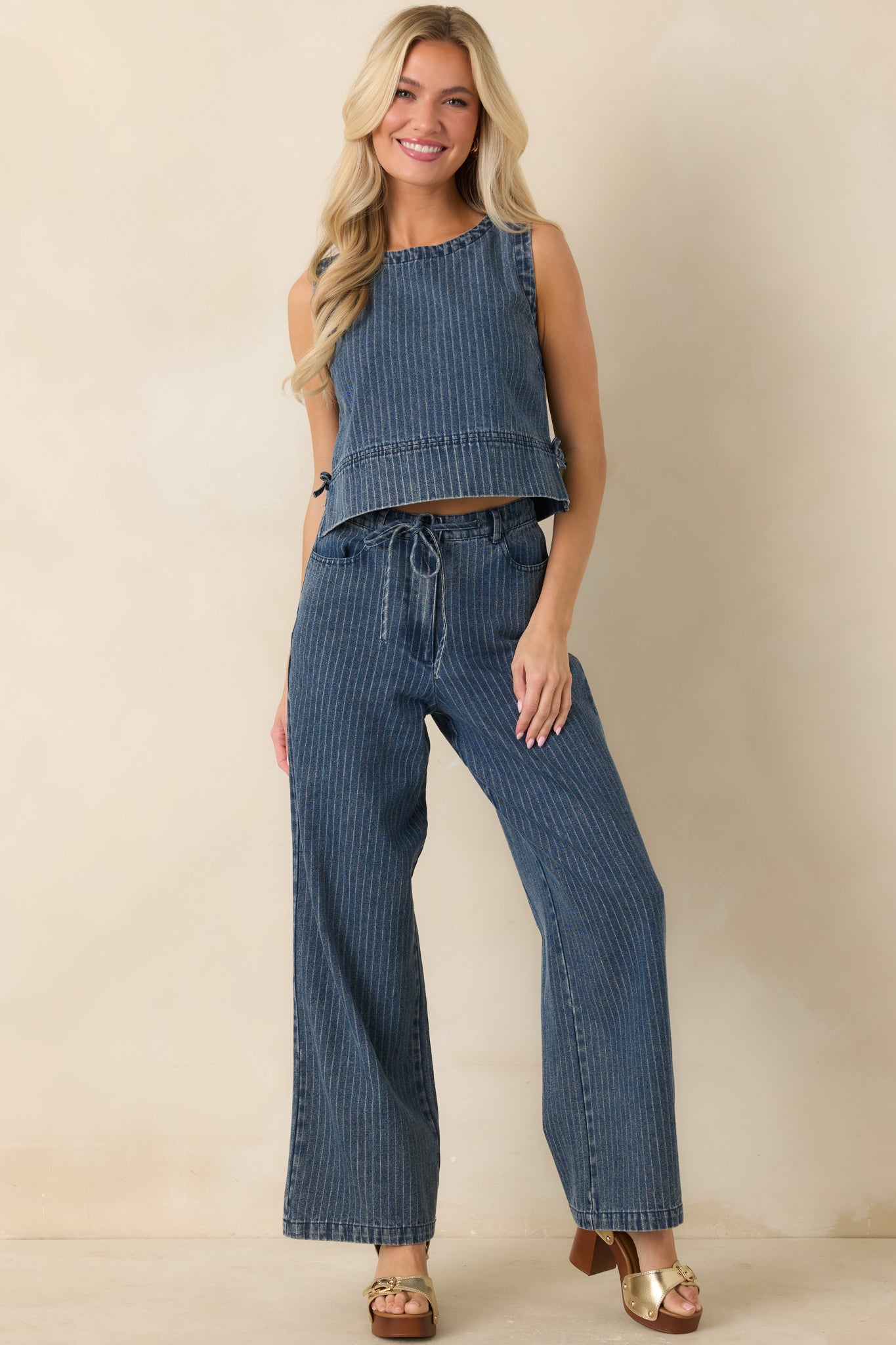 Indigo striped top shown in full length emphasizing the sleeveless design and easy, airy fit with subtle denim texture.