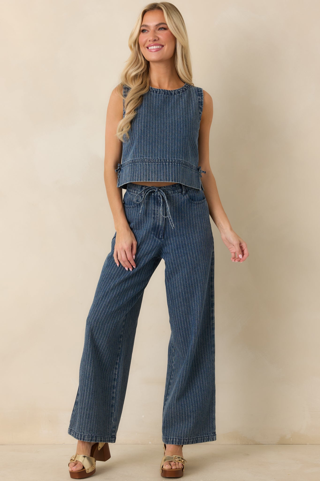 Front full view highlighting the elastic waistband and adjustable drawstring tie paired with a soft vertical stripe pattern.