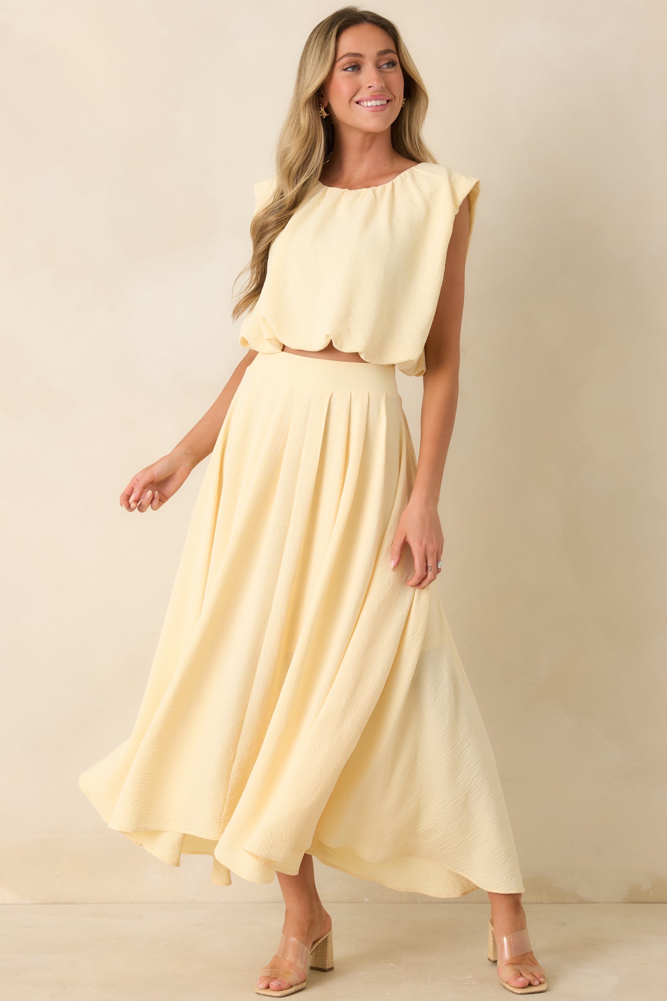 Light yellow maxi skirt featuring a breezy full-length silhouette, stretchy elastic waistband, and softly curved flowing hem.