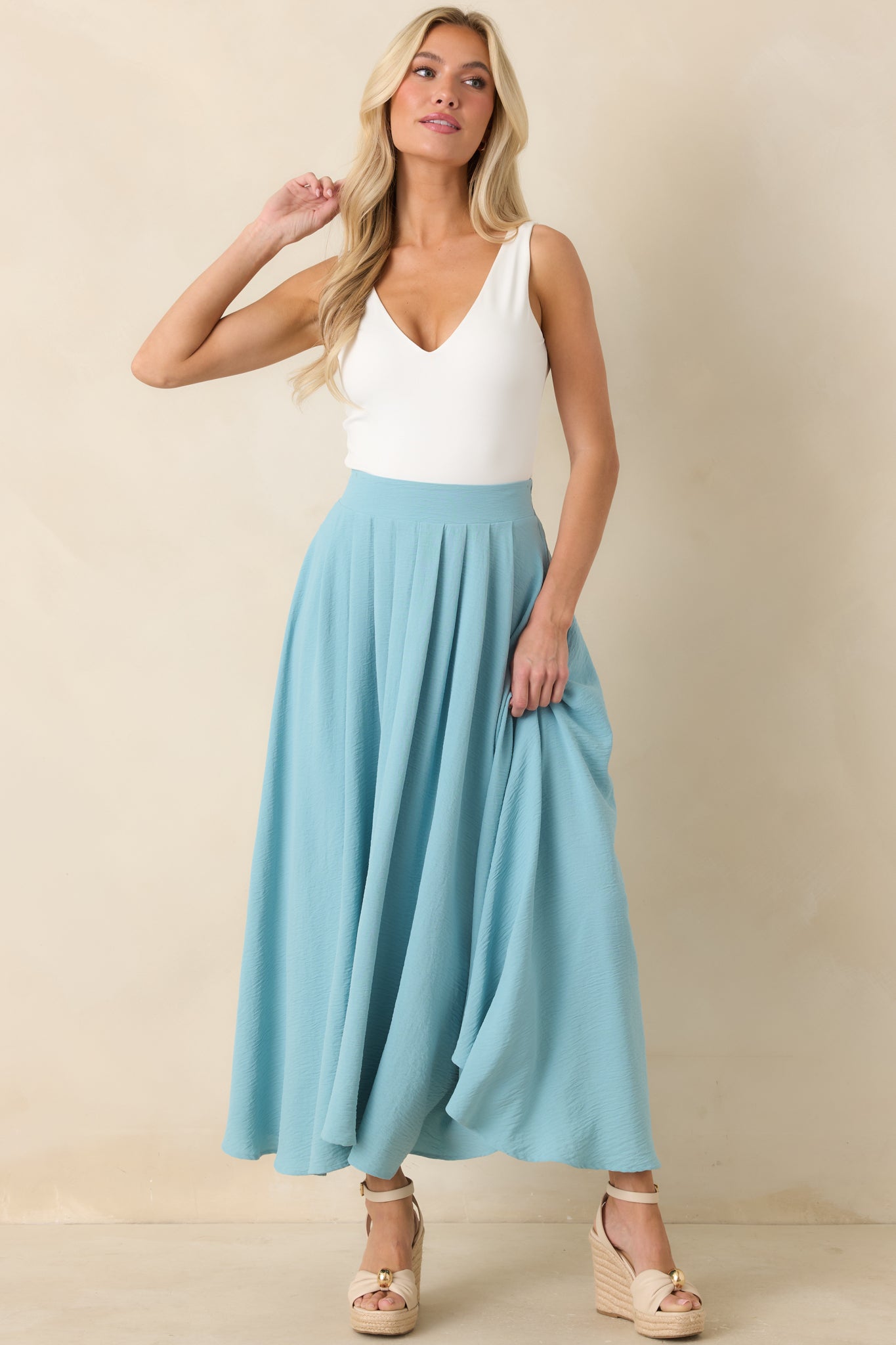 Flowy turquoise maxi skirt showcasing a relaxed silhouette, full lining, and sweeping curved hem.