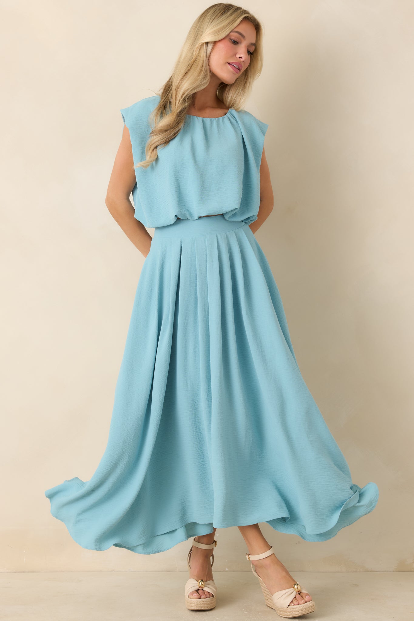Turquoise maxi skirt showcasing a fluid silhouette, fully lined design, and graceful curved hem detail.